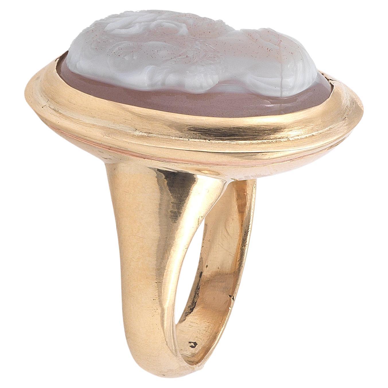 

Oval, depicting the profile of a man with curling hair, facing left, wearing robes, within a yellow gold mount, cameo length 2.3cm, width 1.7cm, ring size 7 1/2

