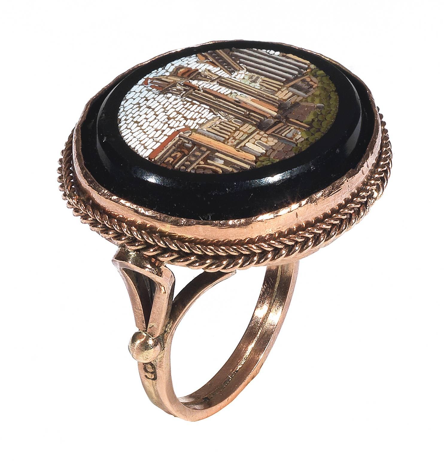 
The oval cut mosaic plaque depicting the Fori Romani ruins in Rome, on black ground within reeded bordered later rose gold mount.

Finger size 7 

Weight: 8.5 gr