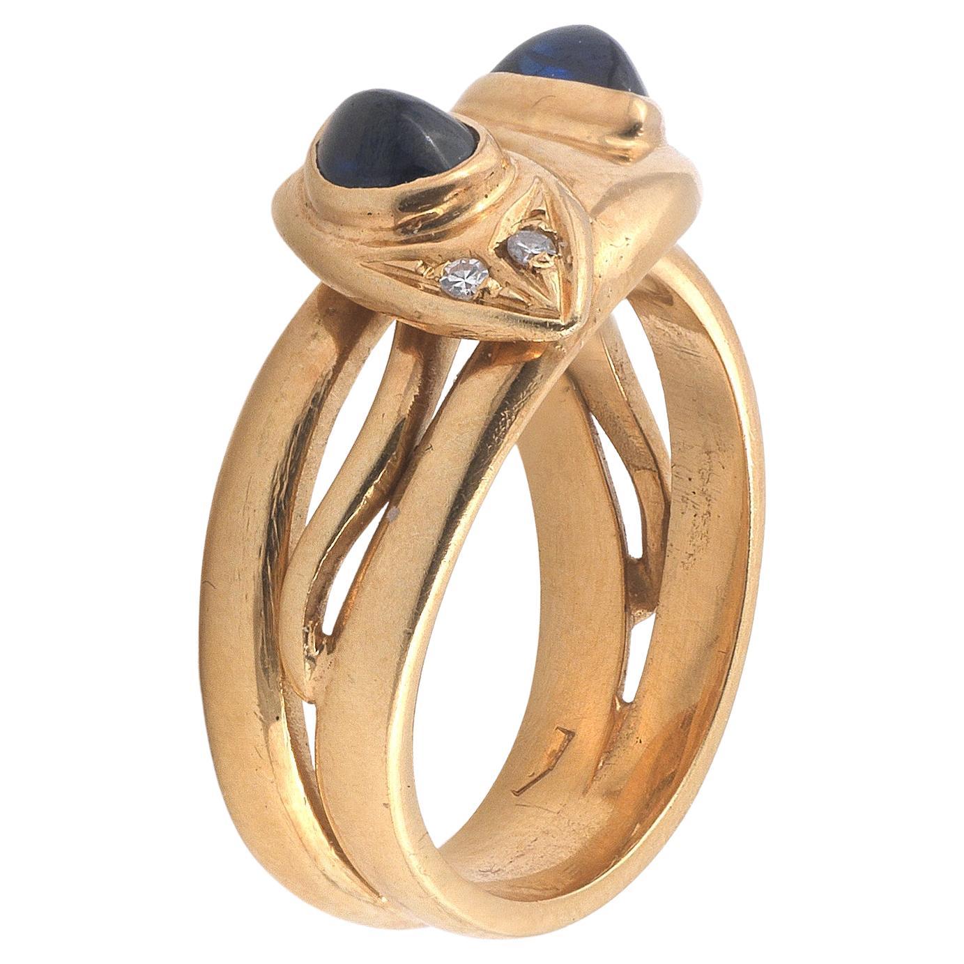 

The mount modelled as two entwined snakes, each with a cabochon sapphire set in it's head and diamond eyes, finger size 7