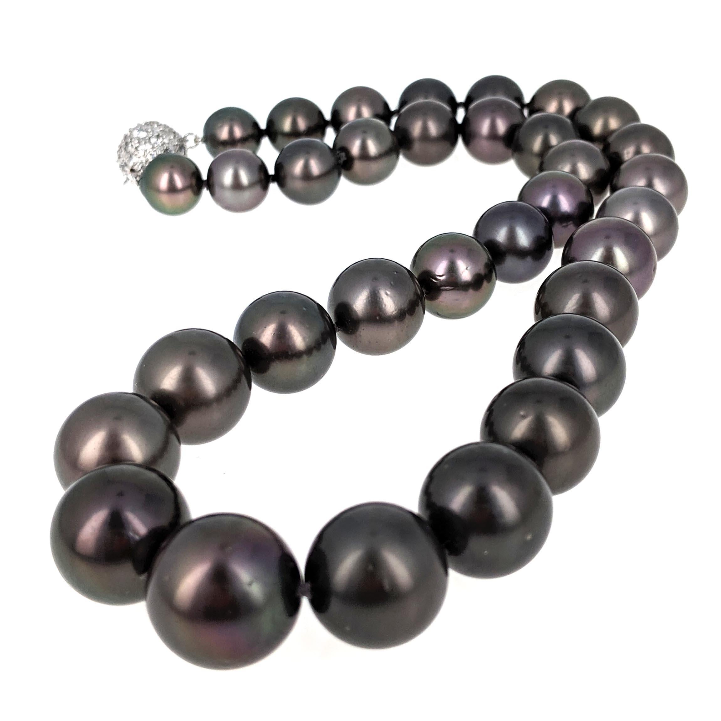 This striking pearl necklace is comprised of a single strand of 33 black Tahitian cultured pearls ranging in sizes from 10.60 mm - 14.92 mm. The pearls are set in a graduated line and held together with a round 18 karat white gold twist clasp that