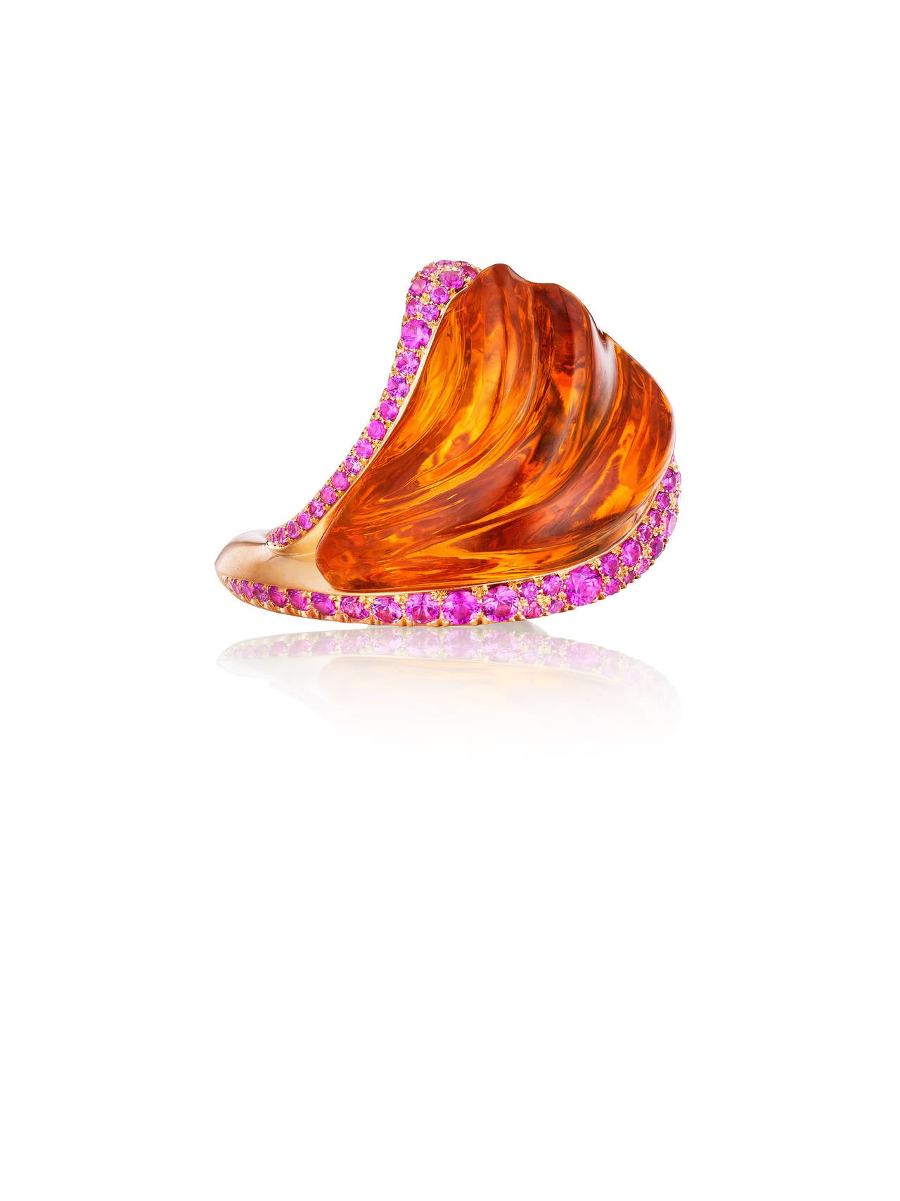 This vibrant ring features a hand-carved 58 ct citrine complimented by hot pink sapphires set in 18K yellow gold.

Internationally award winning designer Naomi Sarna creates gem carvings and jewels of unusual beauty. She is represented in the