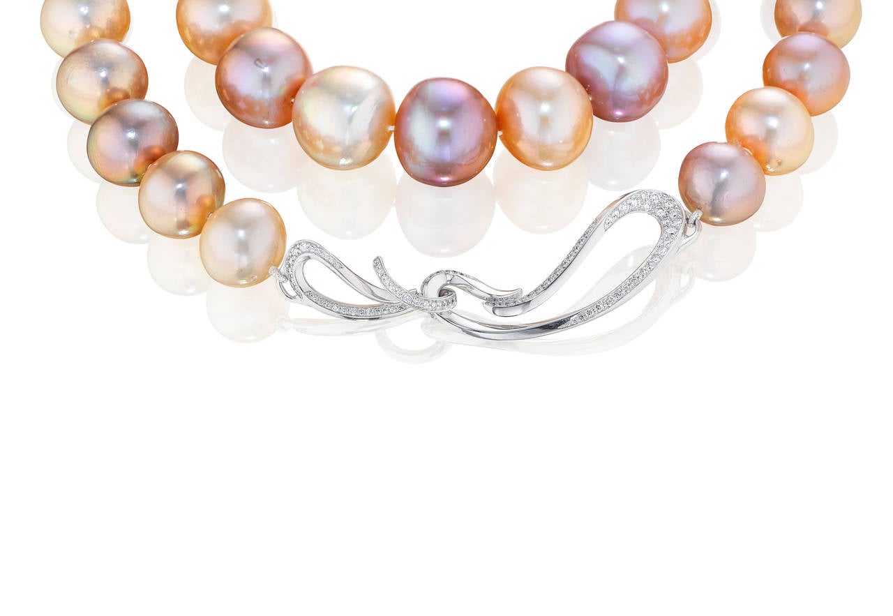 Strand of peach and purple freshwater Pearls (12.5-16.5 mm) finished with our signature clasp. The clasp is 18K White Gold and approximately 1.5 cts of VS-G white diamonds.

Internationally award winning designer Naomi Sarna creates gem carvings and