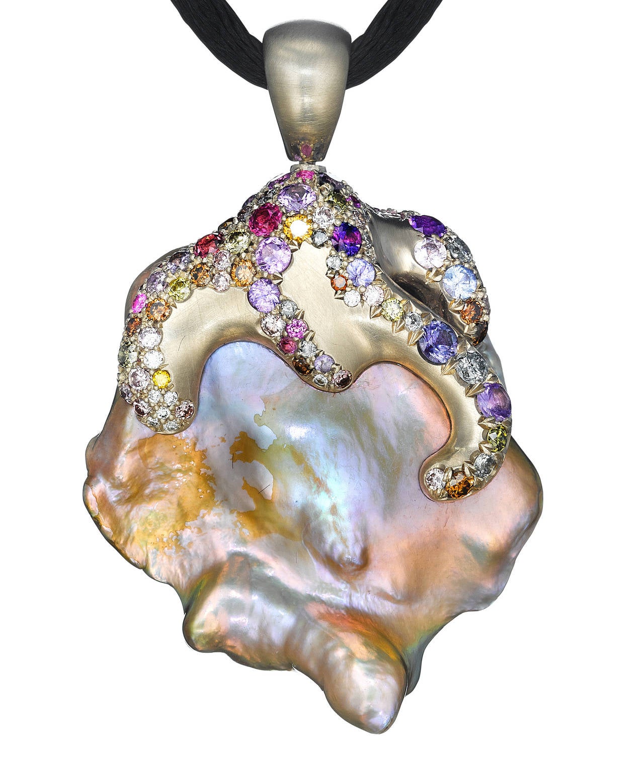Freshwater pearl pendant with 18k palladium white gold, pink diamonds, olive diamonds, and multicolored sapphires.

Internationally award winning designer Naomi Sarna creates gem carvings and jewels of unusual beauty. She is represented in the
