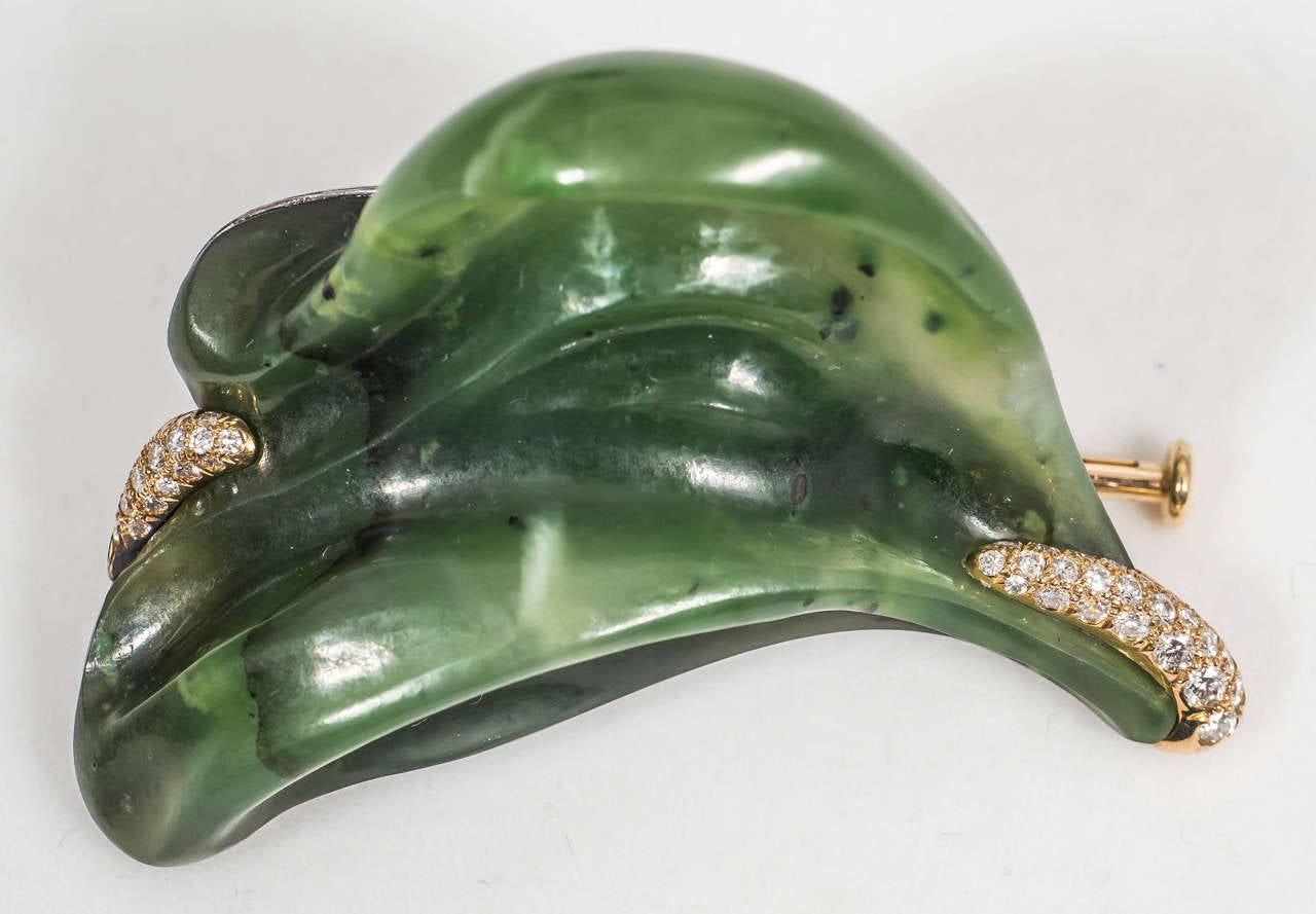 A hand-carved nephrite jade brooch accentuated with 18K yellow gold and 42 VS-F-G white diamonds. The back of the brooch is made of blackened sterling silver. 

Internationally award winning designer Naomi Sarna creates gem carvings and jewels of