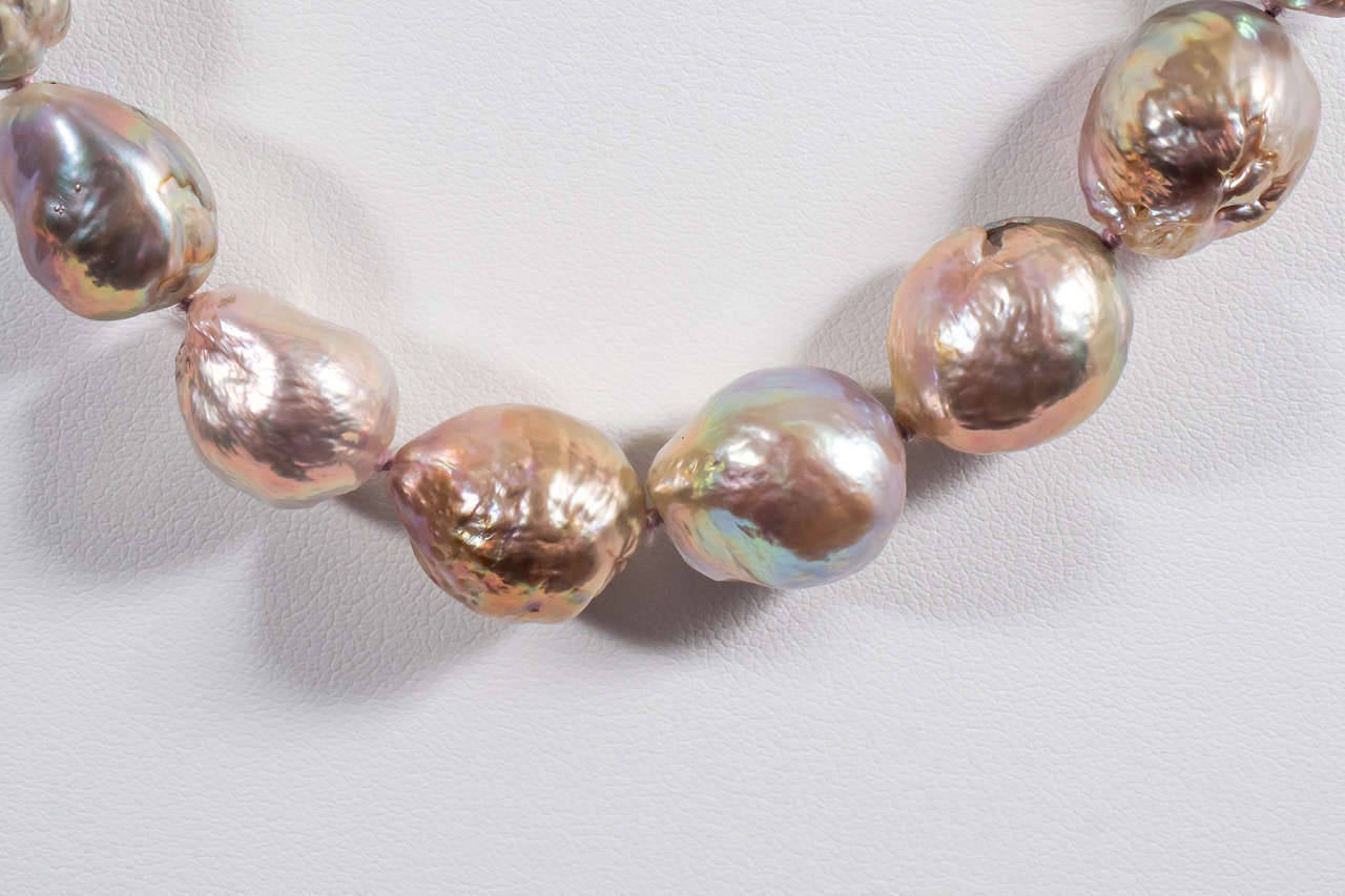 A single strand necklace of exceptionally iridescent, natural color kasumigaura-like Chinese pearls. It is finished with Naomi Sarna's signature full-diamond clasp which is made of 18k yellow gold and is set with approximately 1.5 cts of VS-F-G
