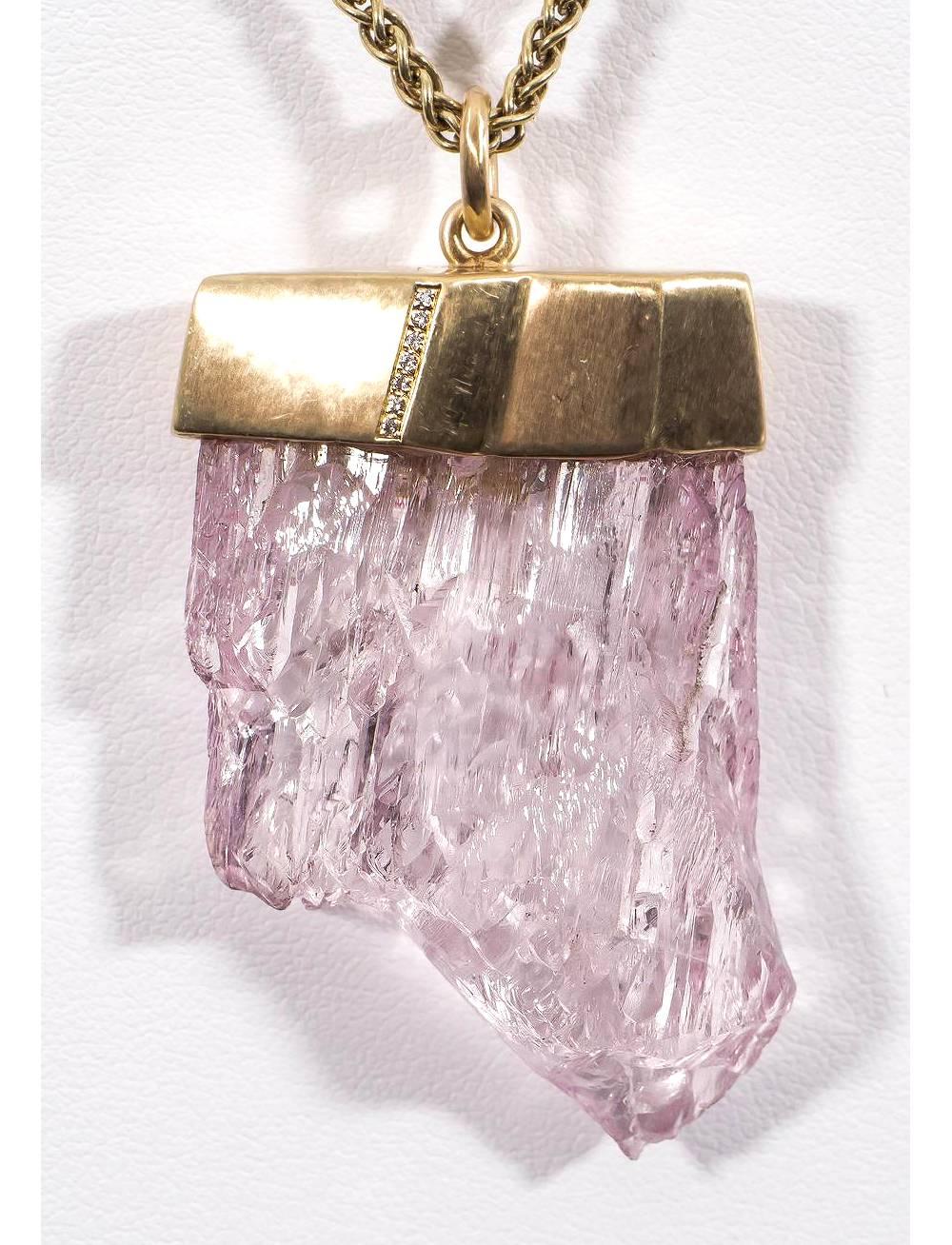 This beautiful, unique pendant features a natural, uncut pink kunzite crystal set in 18K yellow gold with VS-FG white diamonds. Chain not included.

Internationally award winning designer Naomi Sarna creates gem carvings and jewels of unusual