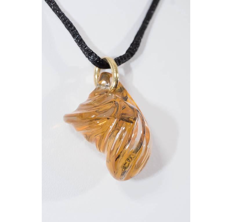 Unusual hand-carved Madagascar iron oxide included quartz (74 ct) on 18K yellow gold. 

Internationally award winning designer Naomi Sarna creates gem carvings and jewels of unusual beauty. She is represented in the Smithsonian's Permanent