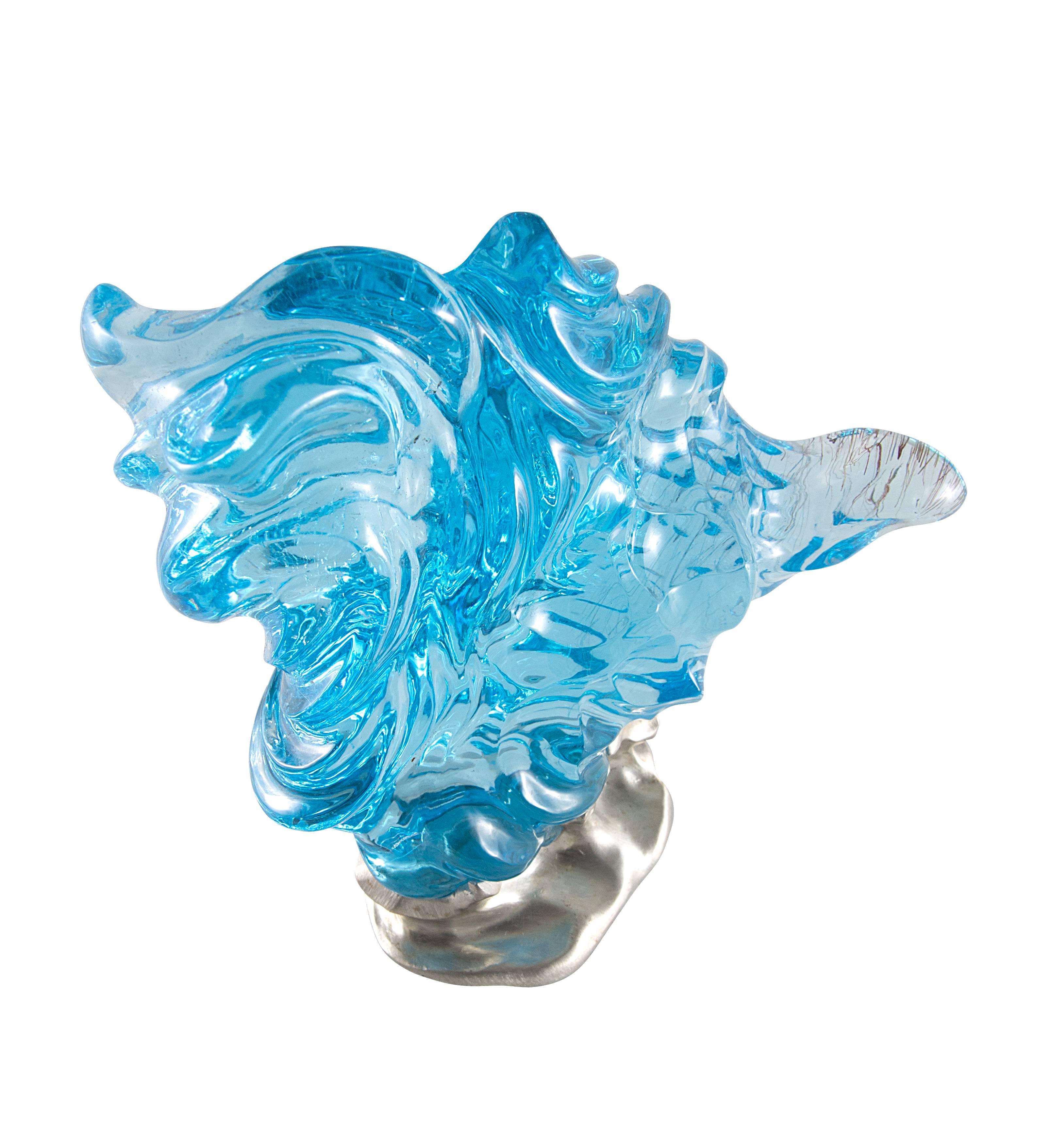 Stunning hand-carved 1,975 ct (395 gm) rutilated topaz with a custom sterling silver base.

Internationally award winning designer Naomi Sarna creates gem carvings and jewels of unusual beauty. She is represented in the Smithsonian's Permanent