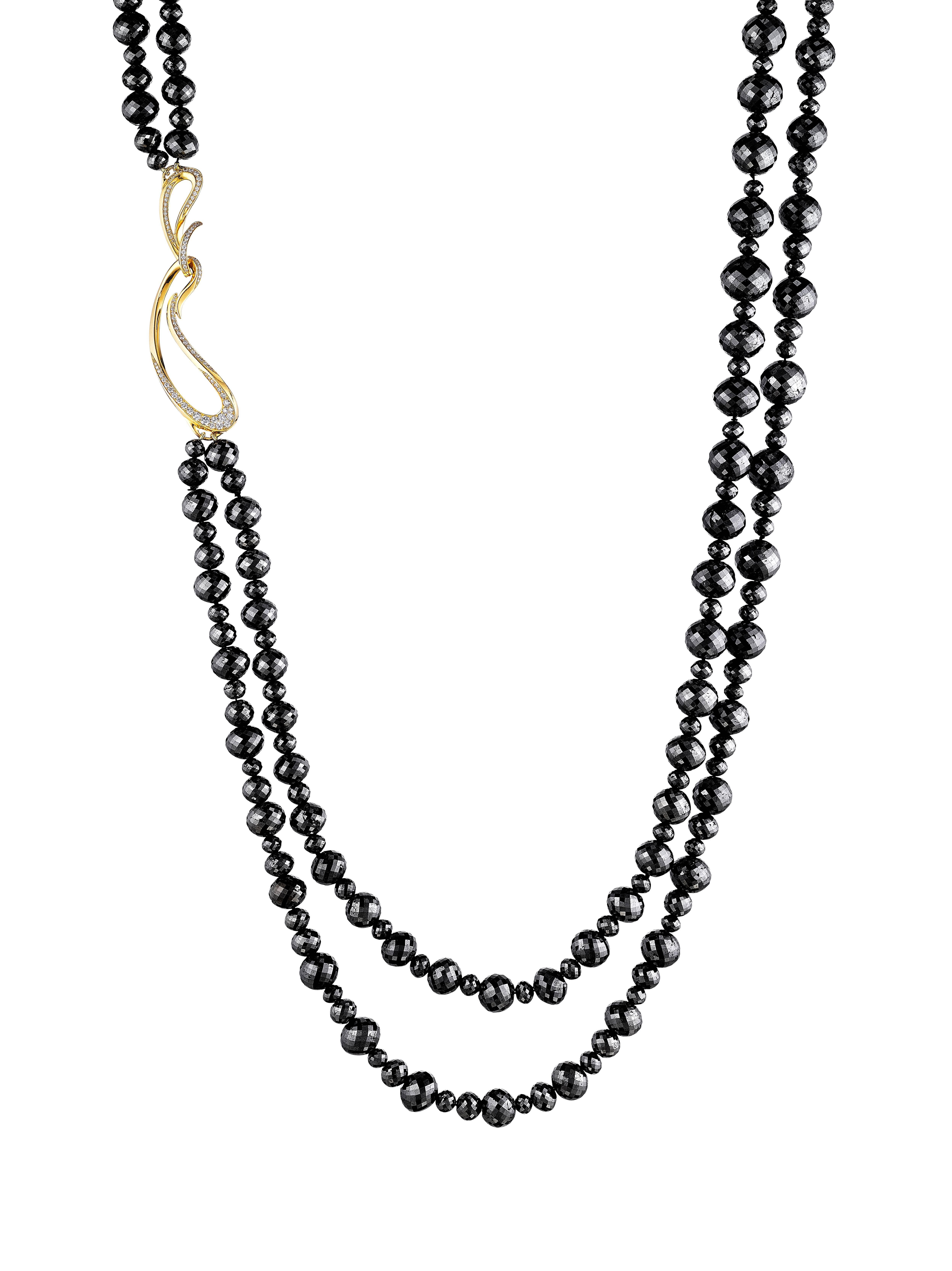 This spectacular double-strand necklace has approximately 770 ct of scintillating 4-11 mm black diamond beads. It is finished with Naomi Sarna's signature 18K yellow gold clasp set with beautiful VS-F-G white diamonds. This necklace can be doubled