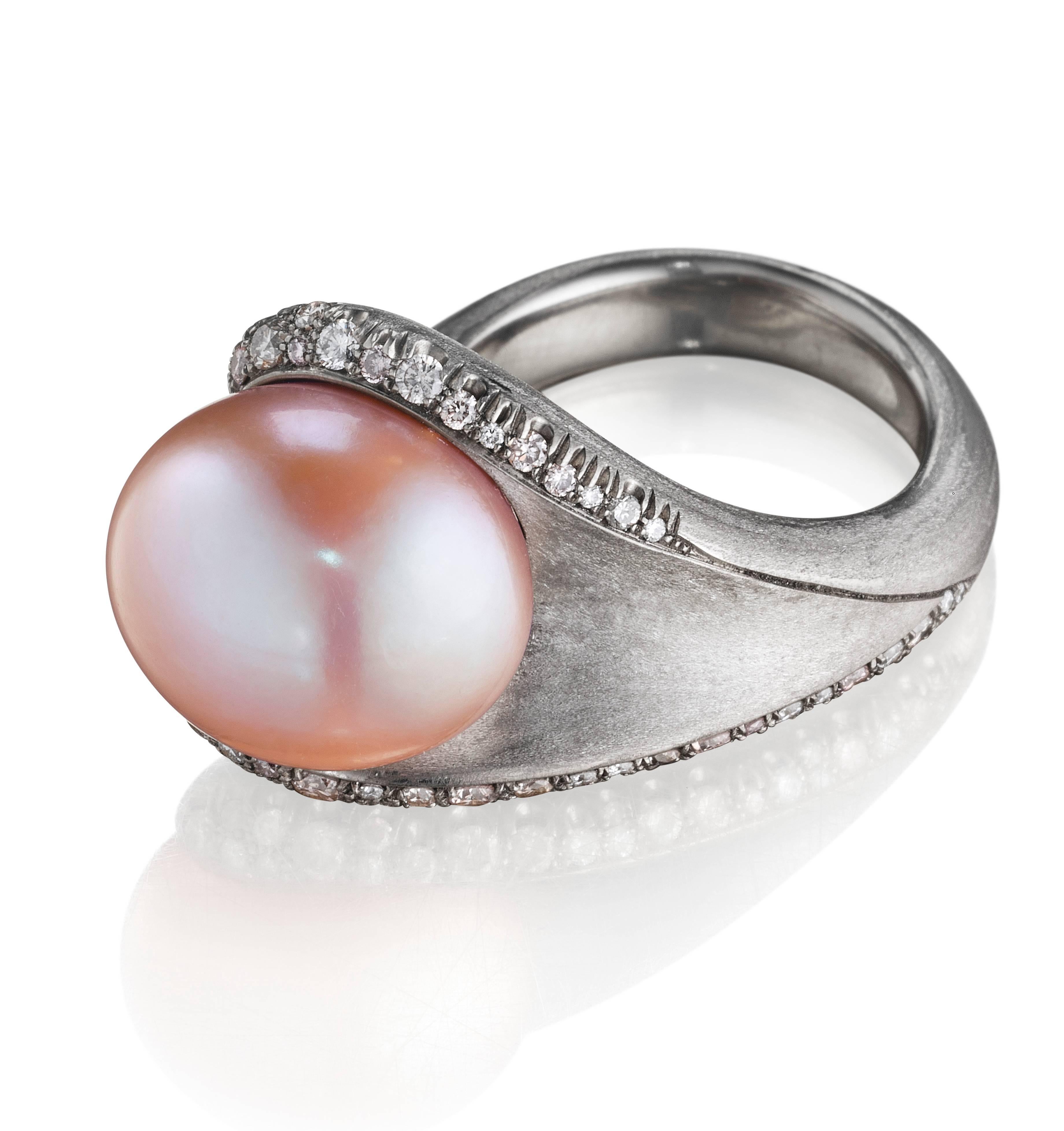 This elegant hand-crafted ring features a an exceptionally beautiful 15.5 ct pale pink freshwater pearl set in 18K natural palladium white gold with an assortment of VS-FG white diamonds and pink diamonds. Like all rings from Naomi Sarna, this is an