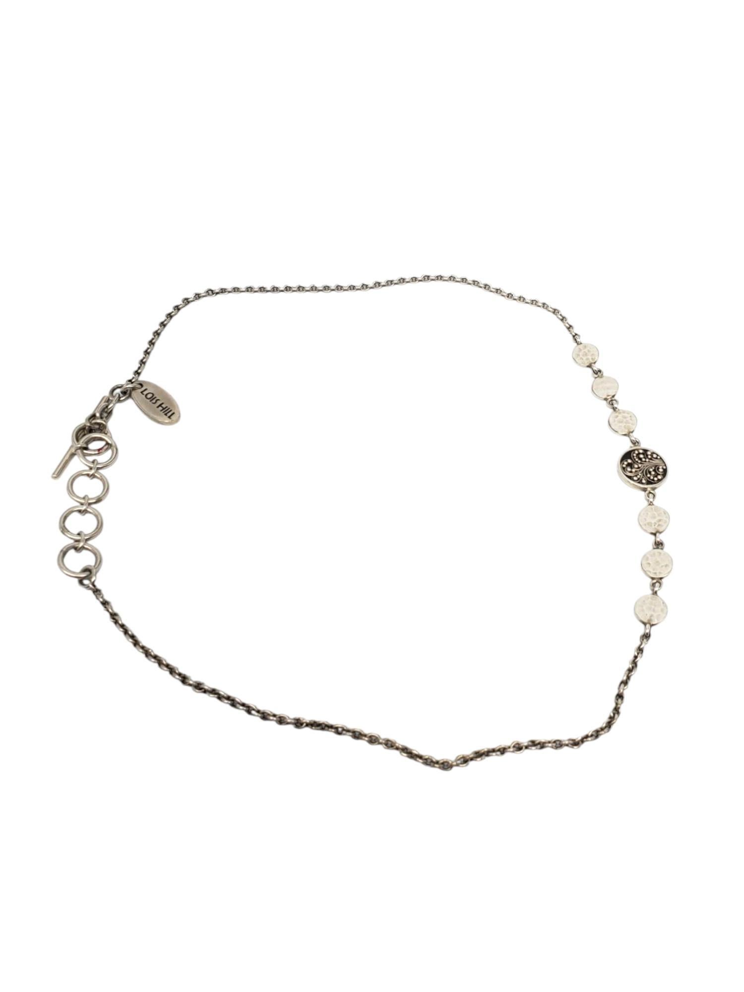 Collana con ciondolo a medaglione in filigrana di Lois Hill, in argento 925.

Questa collana unica di Lois Hill è caratterizzata da un medaglione centrale con volute in filigrana affiancato da dischi martellati e strutturati su una catena a maglie