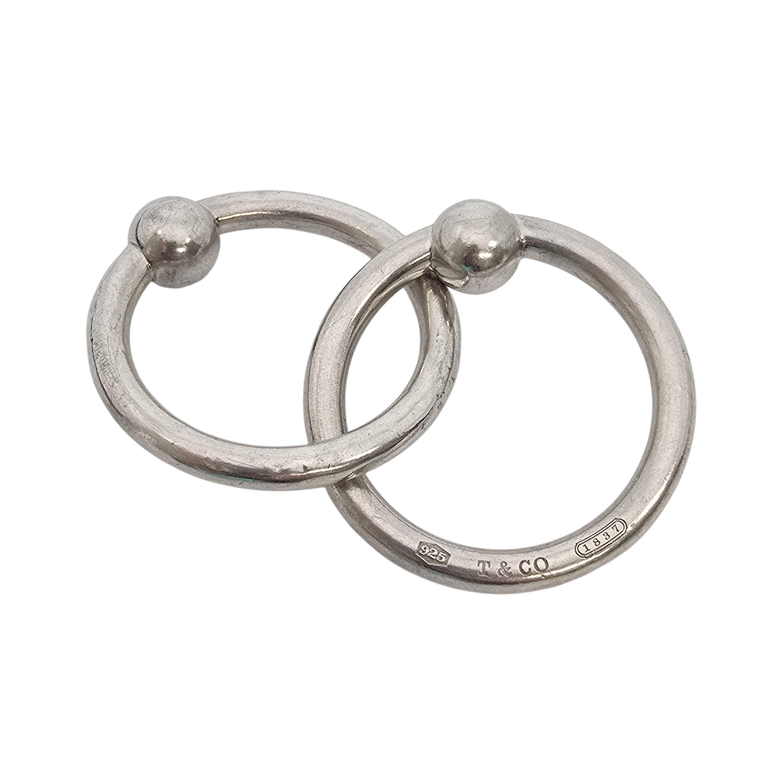 Tiffany & Co Sterling Silver 1837 Double Ring Rattle with box

A sweet baby rattle in Tiffany's iconic 1837 design depicting the year Tiffany was founded. It features 2 interlocking round rattles, one of the rattles is inscribed 925 T&CO 1837.