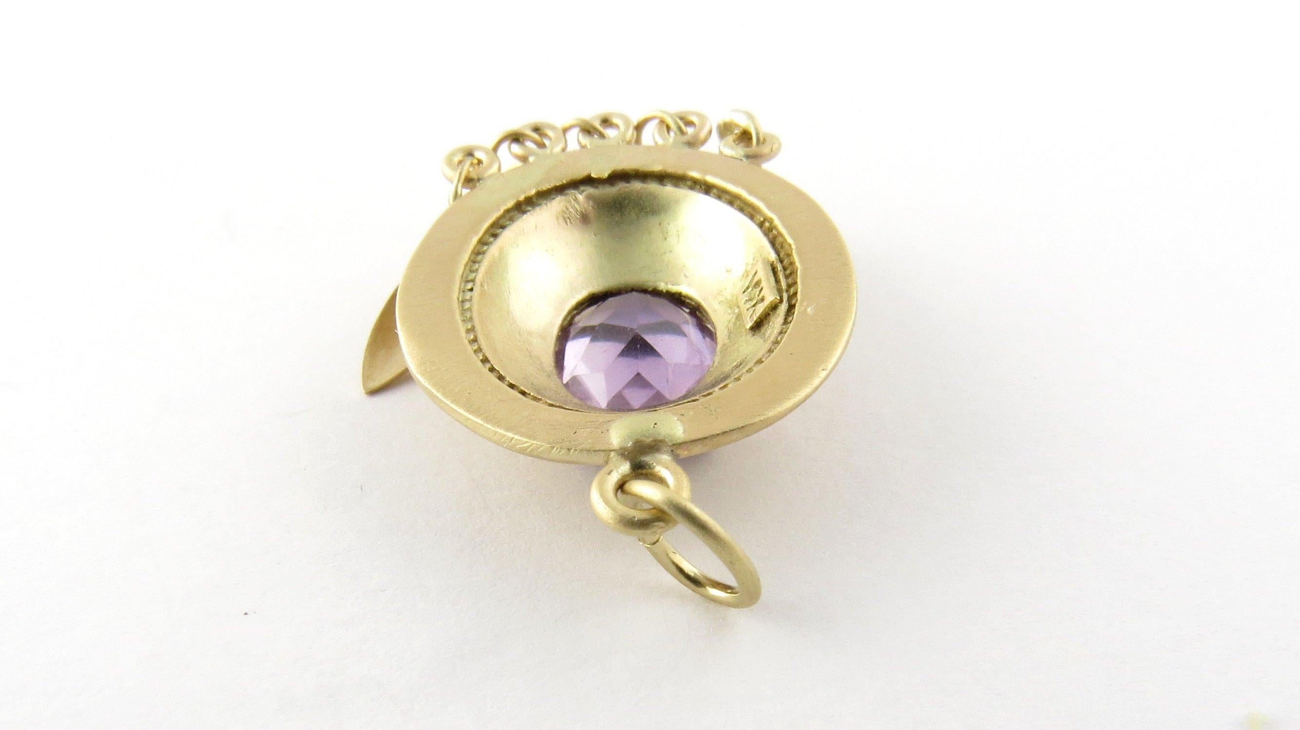 Vintage 14 Karat Yellow Gold Amethyst Pendant. This lovely pendant features one genuine oval amethyst gemstone (12 mm x 9 mm) set in exquisitely detailed 14K yellow gold.
Size: 30 mm x 17 mm. Weight: 2.9 dwt. / 4.6 gr. Stamped: 14K
Very good