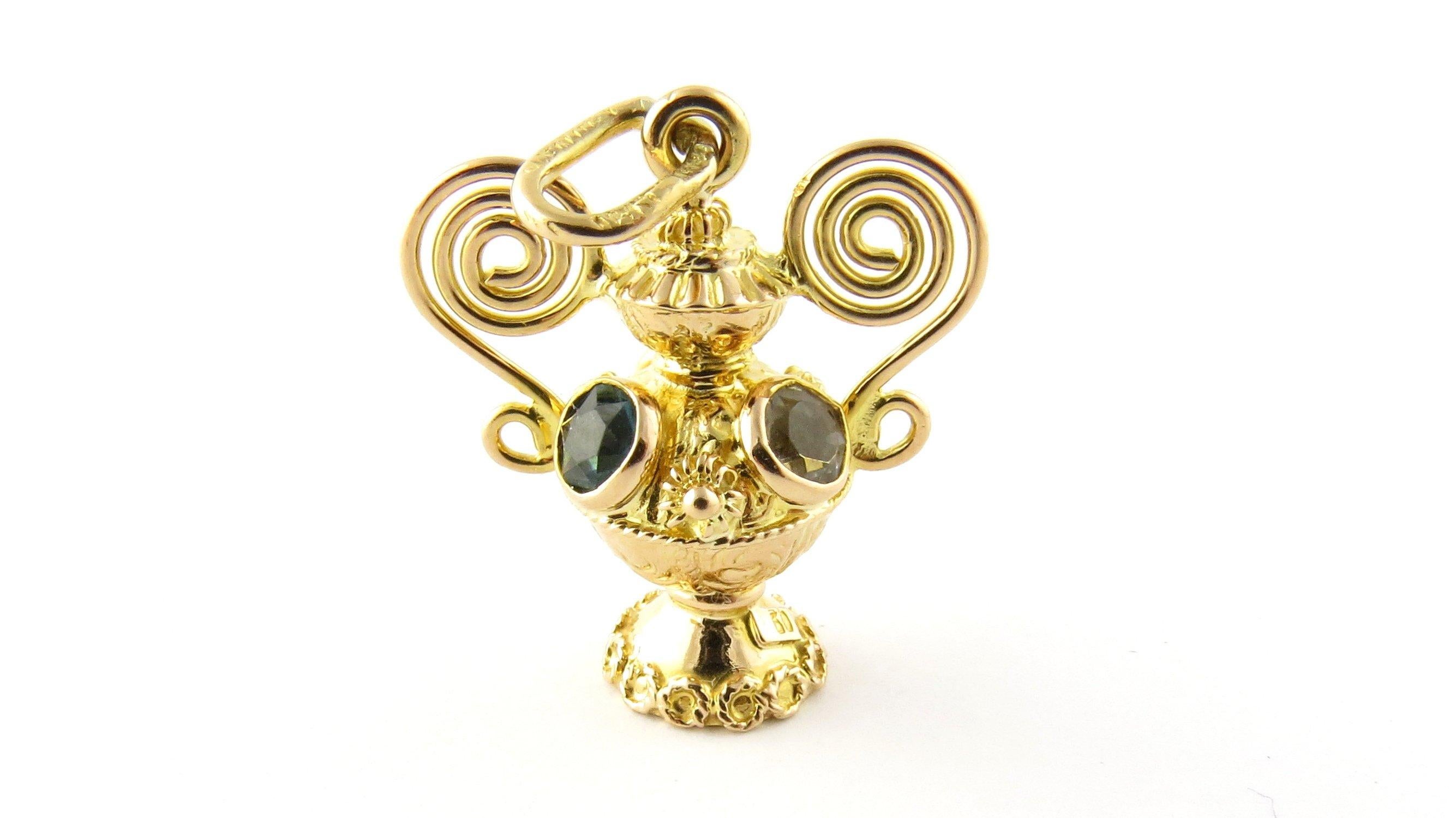 Vintage 18 Karat Yellow Gold Vase Pendant with Colored Stones
This lovely pendant features an ornate vase decorated with three colored stones (amber, light blue, blue/green) set in meticulously detailed 18K yellow gold.
Size: 27 mm x 24 mm
 Weight: