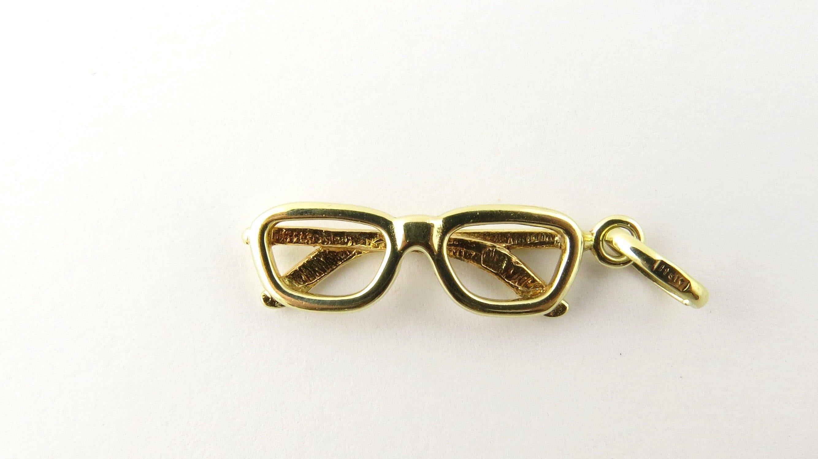 Vintage 14 Karat Yellow Gold Eyeglass Charm - Never lose your glasses again! This lovely 3D charm features a miniature pair of eyeglasses meticulously detailed in 14K yellow gold.
Size: 27 mm x 9 mm (actual charm) Weight: 1.3 dwt. / 2.1gr. Stamped: