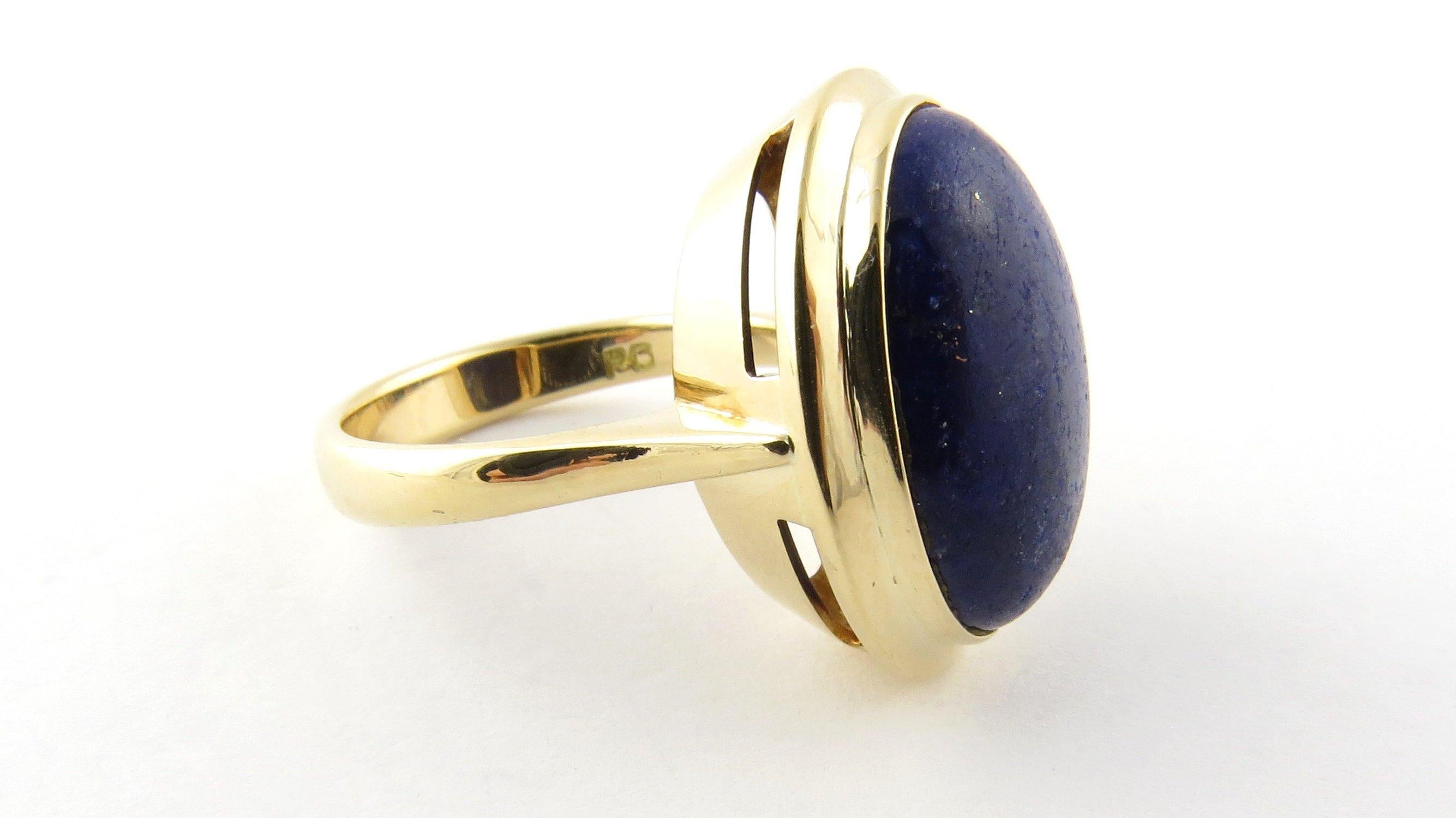 Vintage 14 Karat Yellow Gold and Genuine Blue Lapis Ring Size 6.5. This stunning ring features one oval genuine blue lapis stone (18 mm x 13 mm) set in classic 14K yellow gold. Shank measures 4 mm. 
Ring Size: 6.5 Weight: 5.1 dwt. / 8.0 gr. Stamped: