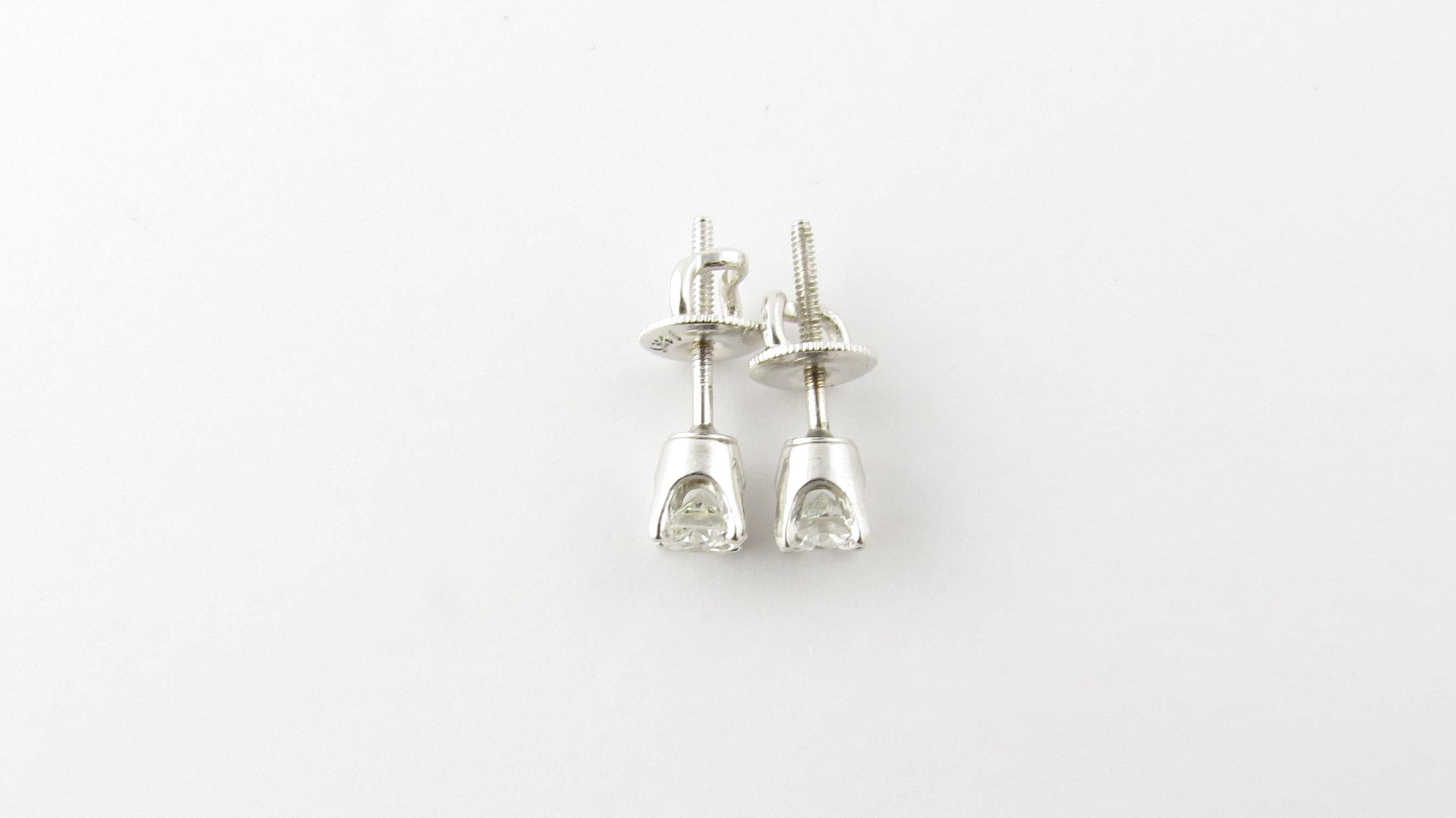 Vintage 14 Karat White Gold Diamond Stud Earrings .50 ct. twt.- These sparkling stud earrings each feature one round brilliant cut diamond set in classic 14K white gold. Screw back closures. Approximate total diamond weight: .50 ct. Diamond color: G