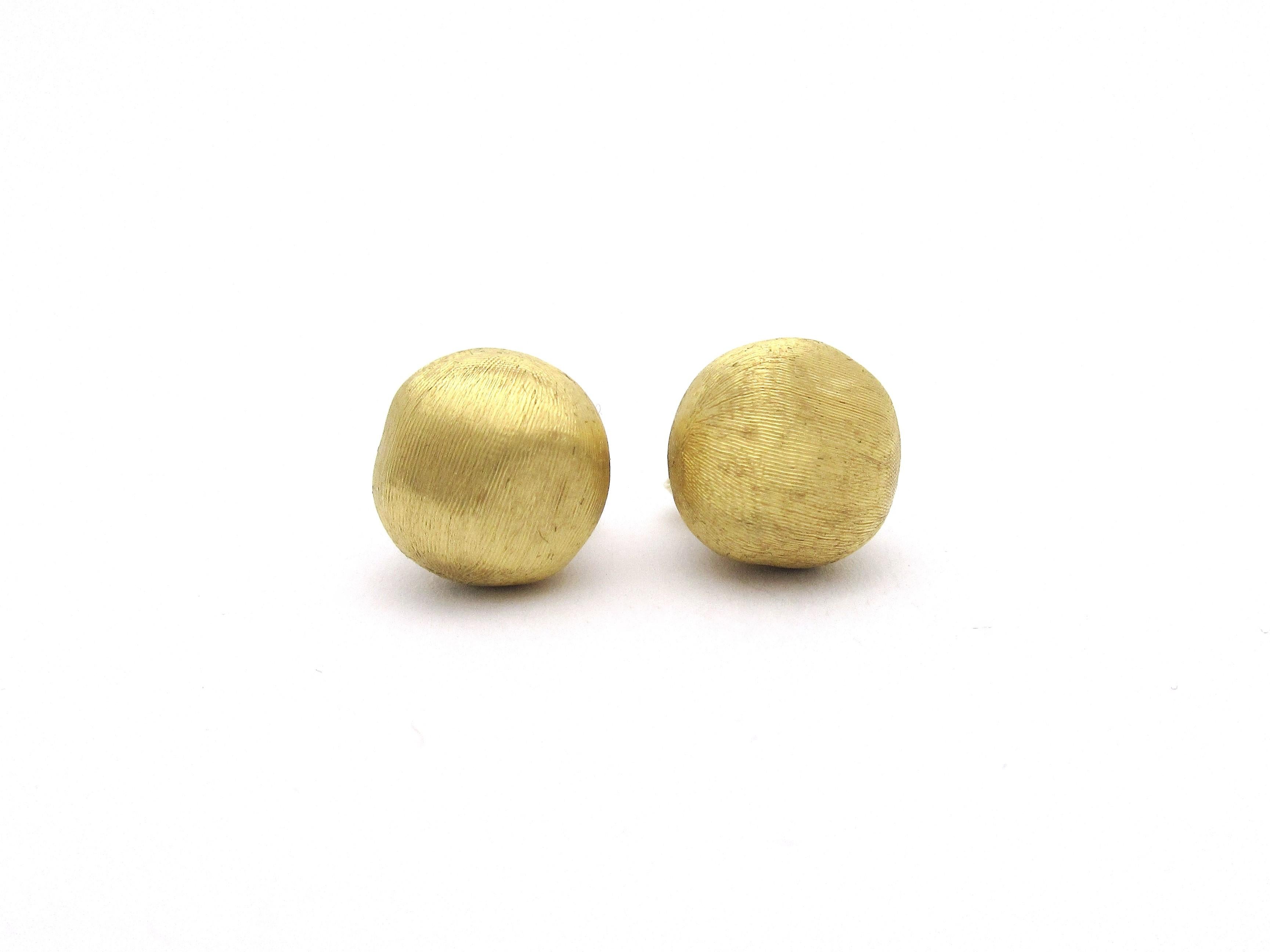 A lovely pair of stud earrings by designer Marco Bicego from his Africa collection.  The 18k yellow gold textured pebble measures roughly 10mm and the earrings are fully hallmarked on the back and on the posts.  They come with the original earring