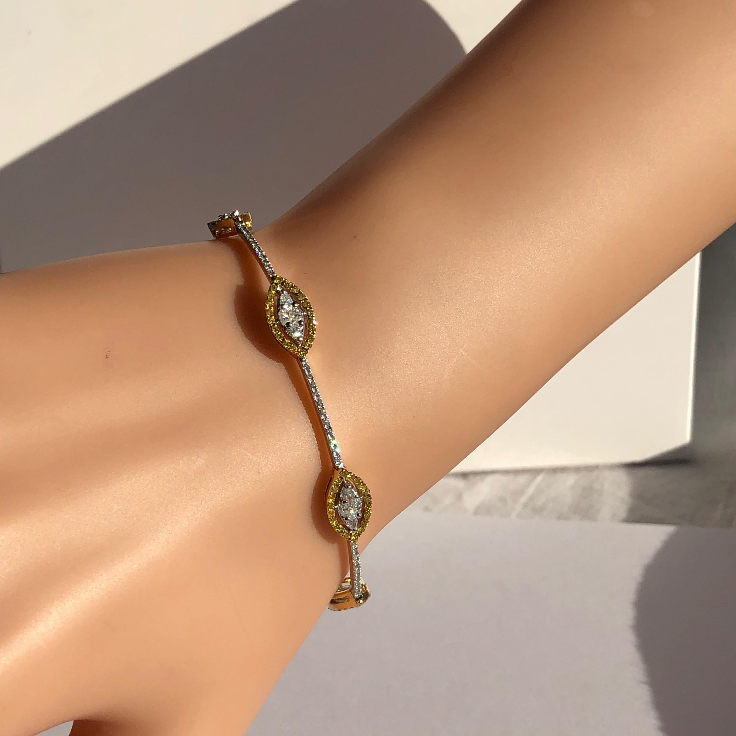 David Morris White Diamond and Yellow Diamond Bracelet

Designed as a diamond bracelet with six navette shaped sections set with marquise diamonds each within a yellow diamond frame

Metal: Platinum and 18K yellow gold 

Diamonds: 24 marquise and