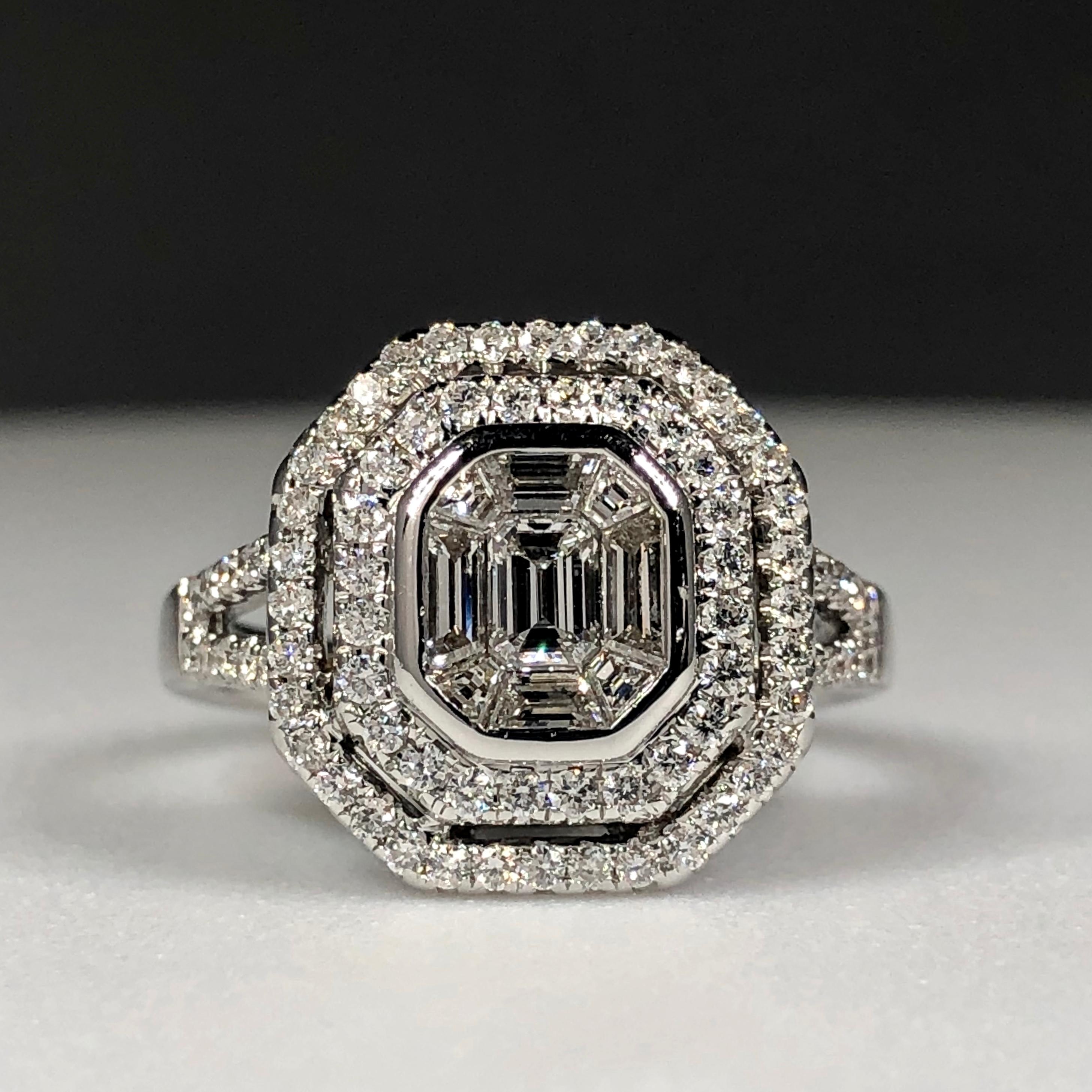 An 18K White Gold Cluster Cocktail Ring Set With An Estimated 1.50ct Of Diamonds 

The Central Illusion Set Baguettes Give The Visual Impression Of One Large Emerald Cut Diamond Surrounded By A Double Halo Of Round Brilliant Cut Bright White