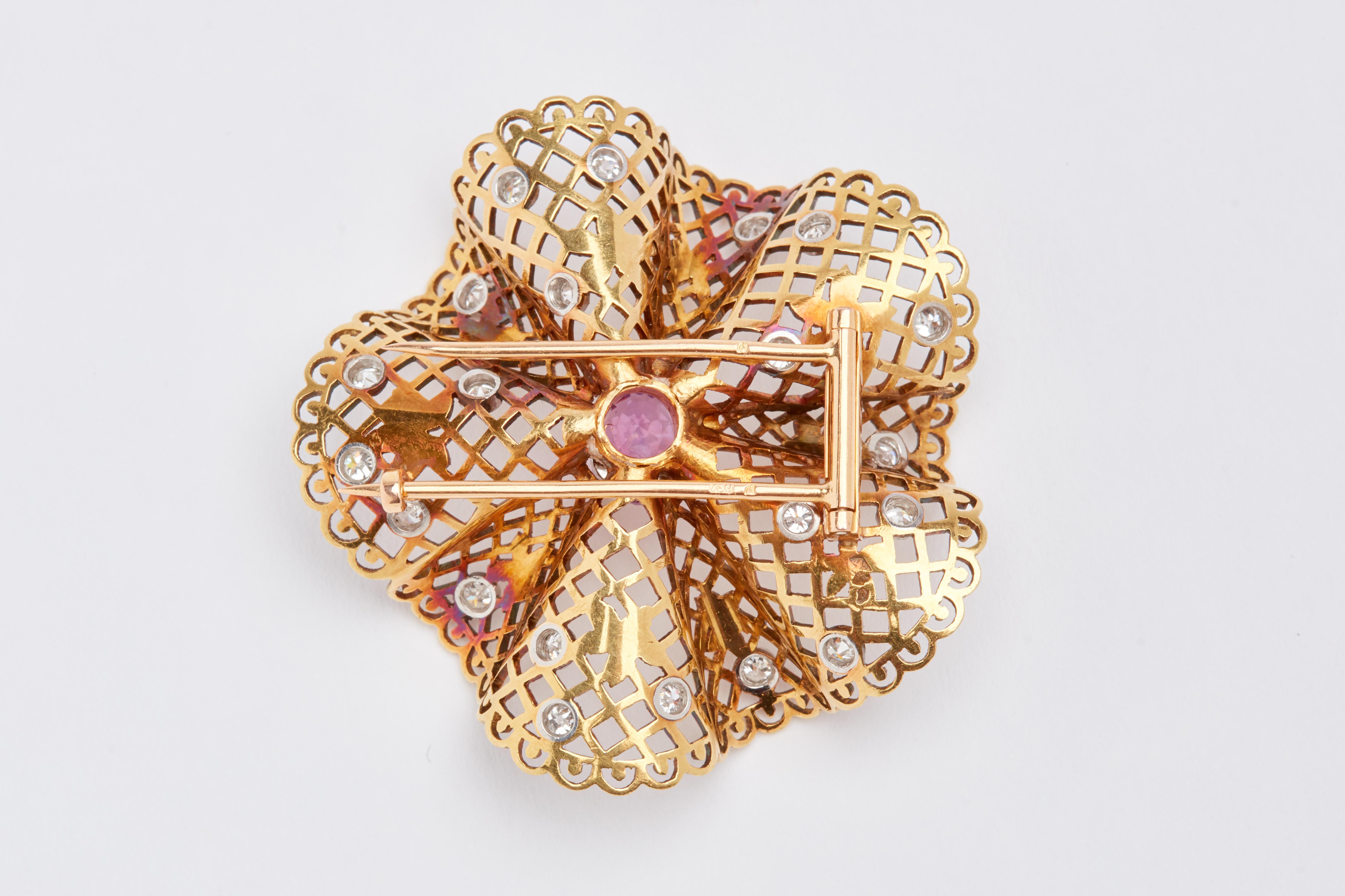 Gold Filligree brooch with pink sapphires and diamonds. Center Stone is a oval cut pink sapphire weight approx 1.75 carats. 20 white old European cut diamonds weighing aprox 2 carat total. 2 inches by 2 inches. 