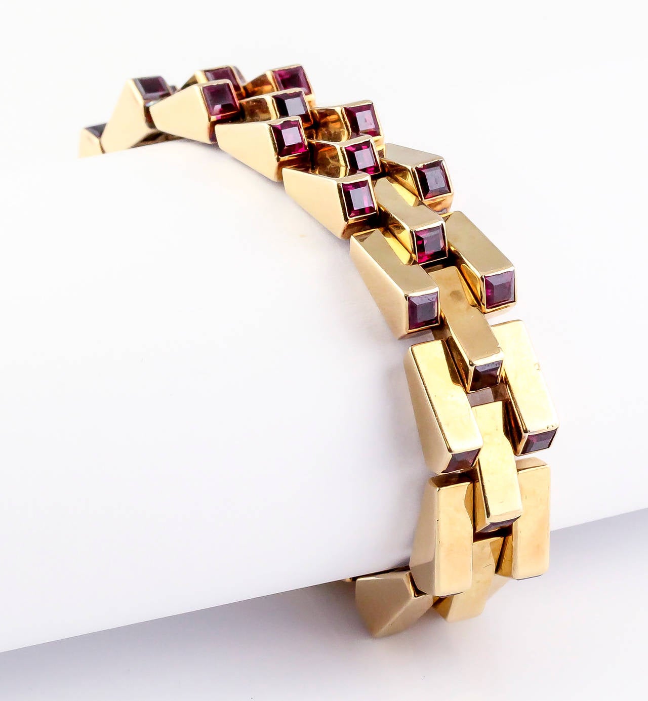 Very rare and unusual ruby and 18K yellow gold escalator bracelet by Boucheron, circa 1940s. It features approx. 8.0-10.0cts of very high quality calibre cut  rubies of a very rich pigeon blood red color.
Hallmarks: Boucheron Paris, reference