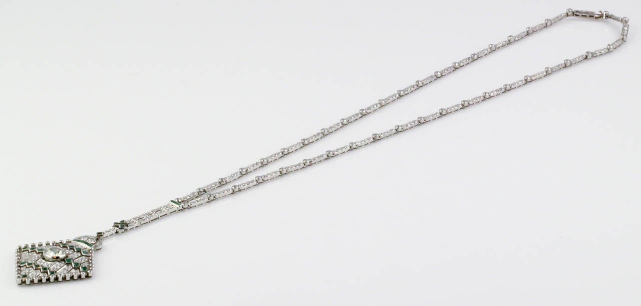 Elegant art deco diamond emerald and platinum necklace, circa 1930s. Diamonds are pave set and high quality, approx. 8.0-9.0cts total weight. Emeralds are also bright green. Pendant is diamond shaped, set with a larger central stone approx .90-1