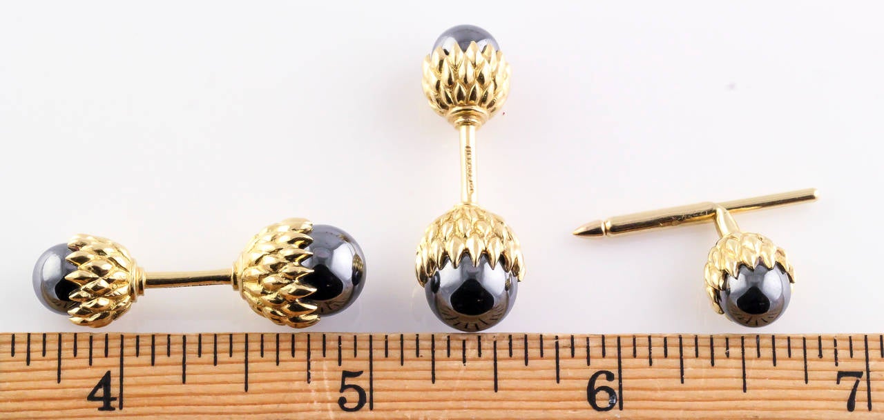 Handsome hematite and 18K yellow gold cufflink and stud set by Tiffany & Co. Schlumberger. The set id designed to resemble acorns, typical of Schlumberger nature designs.

Hallmarks: Tiffany, 18K, Schlumberger.