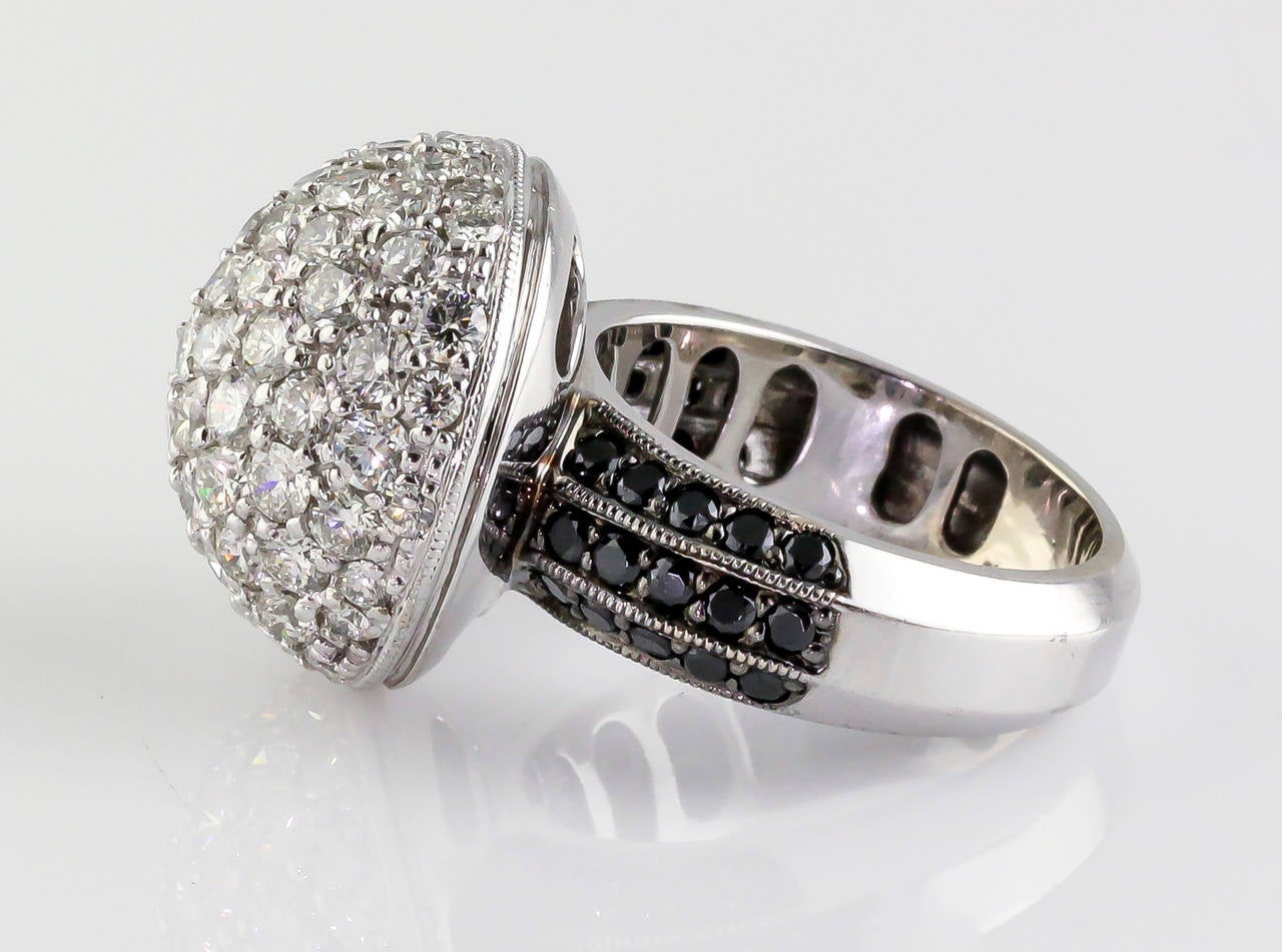 Impressive black and white diamond dome ring set in 18K white gold by De Grisogono. It features high grade round brilliant cut diamonds, approx. 5.0-6.0cts total weight. Size 6. 

Hallmarks: De Grisogono, 750.