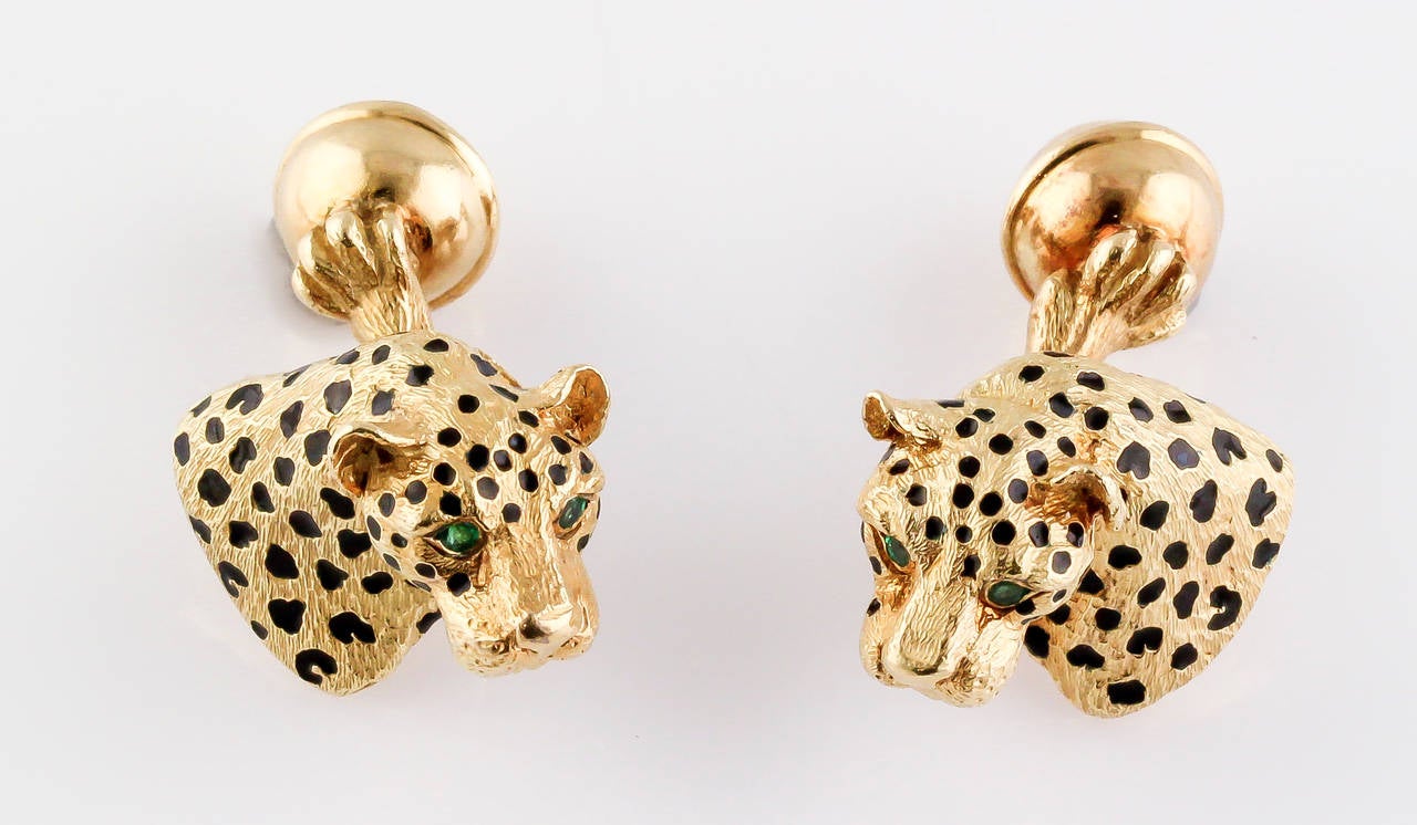 Very handsome 18K yellow gold, black enamel and emerald cufflinks by Tiffany & Co. Germany, circa 1989. They are designed with the resemblance of a leopard, with black enamel spots and emerald eyes.
Hallmarks: Tiffany, 18k, 750, Germany,