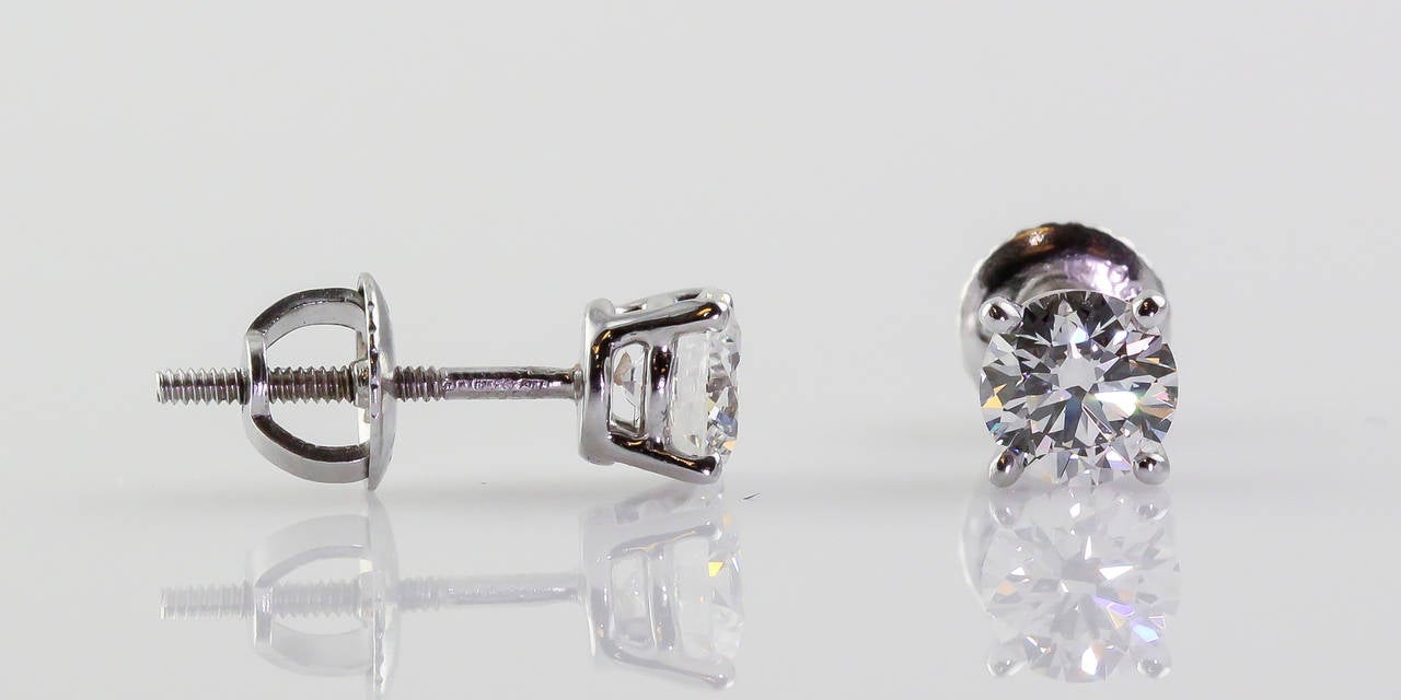 Elegant diamond and platinum stud earrings by Tiffany & Co. They feature very high grade round brilliant cut diamonds of 1.02cts total weight. First is  G color, one VVS2 clarity,  with excellent polish, symmetry and cut as stated in the included