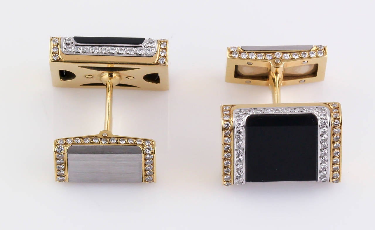 Elegant onyx, diamond and two tone 18K gold cufflinks of French origin, circa 1970s. Front of the cufflinks features an onyx inlay, while the back has a brushed white gold inlay. They feature approx. 1.5cts of high grade round brilliant cut