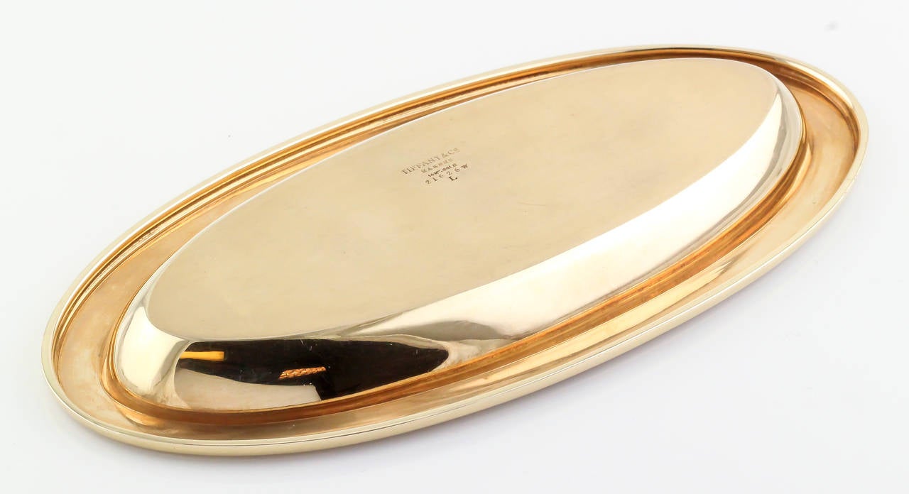 Elegant 14K yellow gold ribbed tray by Tiffany & Co. Makers.
Hallmarks: Tiffany & Co. Makers, 14K, reference numbers.