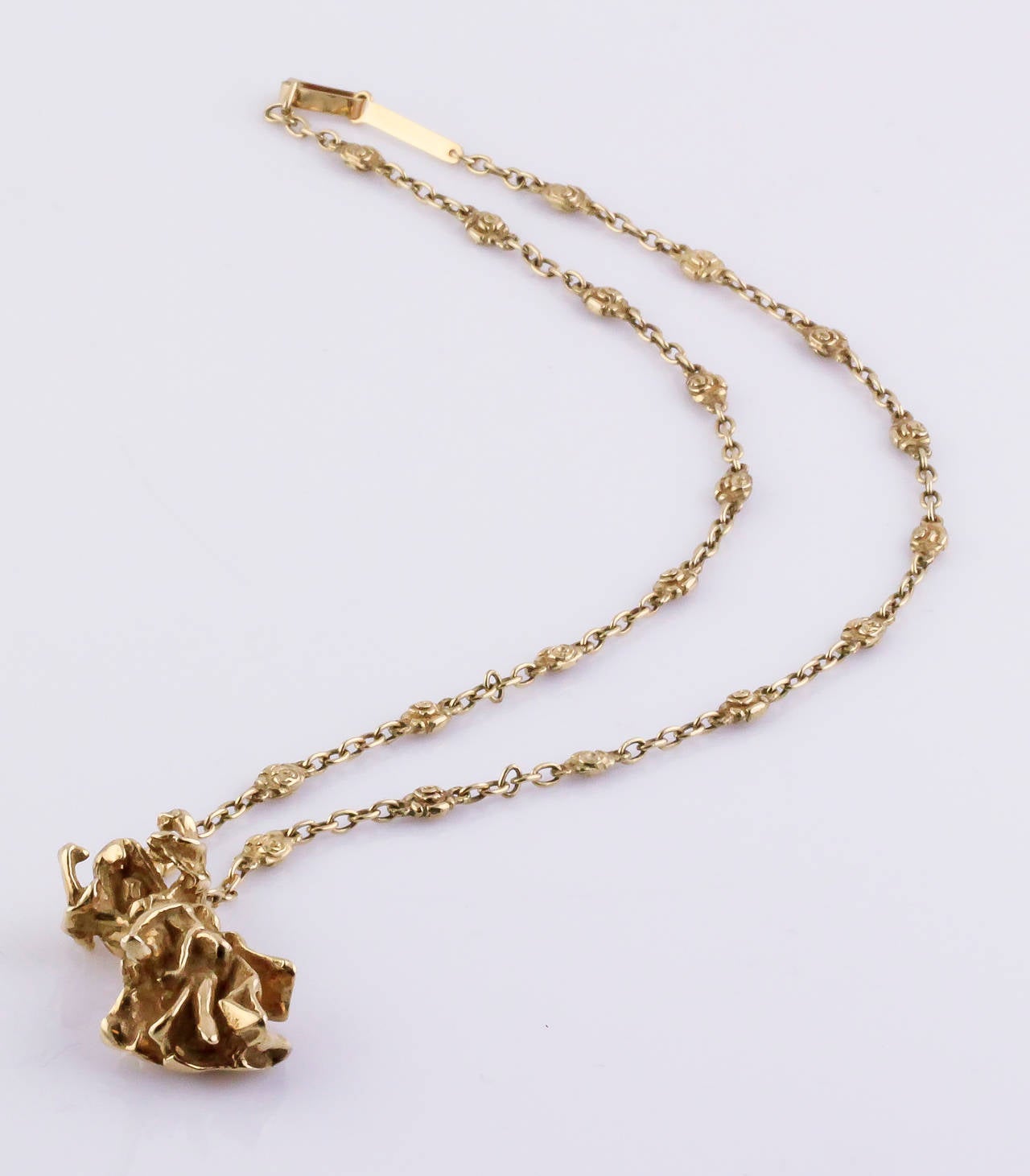 Whimsical 18K yellow gold pendant necklace by Salvator Dali. It features the likeness of Carmen, of the famous opera by Georges Bizet. The chain features rose-like links along with plain links. Limited edition of 1000, this being #109. Pendant