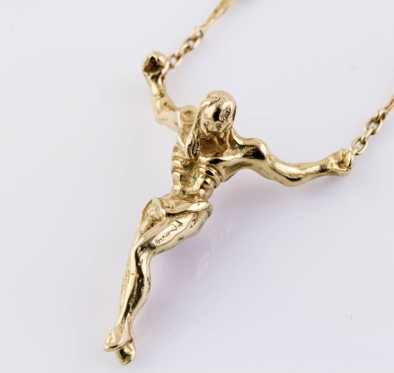 Unusual 18K yellow gold pendant necklace by Salvador Dali. The pendant is in the likeness of Christ, and is known as the 