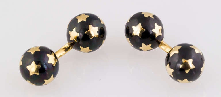 Rare and unusual black enamel and 18K yellow gold cufflink and 4 stud set of French origin. It features round spheres on each end, with outlines of stars. Comes with four studs.
Hallmarks: French 18K gold assay marks, maker's mark, 18K.