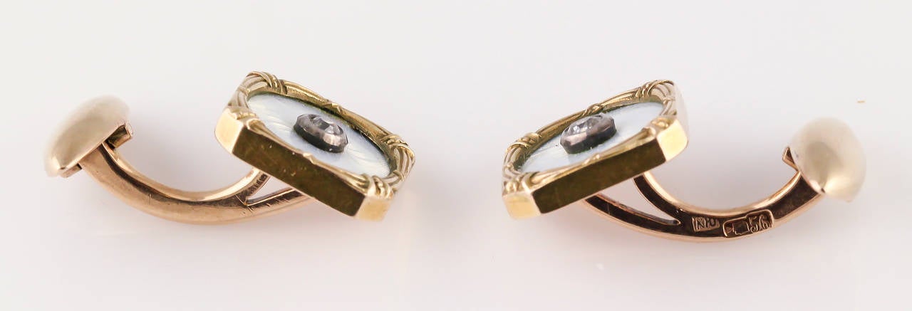 Rare diamond, enamel and 14K yellow gold cufflinks of Russian origin, circa 1880s. They feature old  cut diamonds, surrounded by white enamel. 
Hallmarks:56 zolotniks mark, maker's initials