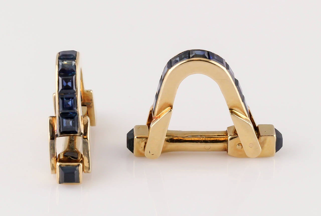 Elegant blue sapphire and 18K gold triangle cufflinks by Boucheron Paris. They feature rich blue sapphires in a channel setting.

Hallmarks: Boucheron Paris, reference numbers, French 18K gold assay marks.