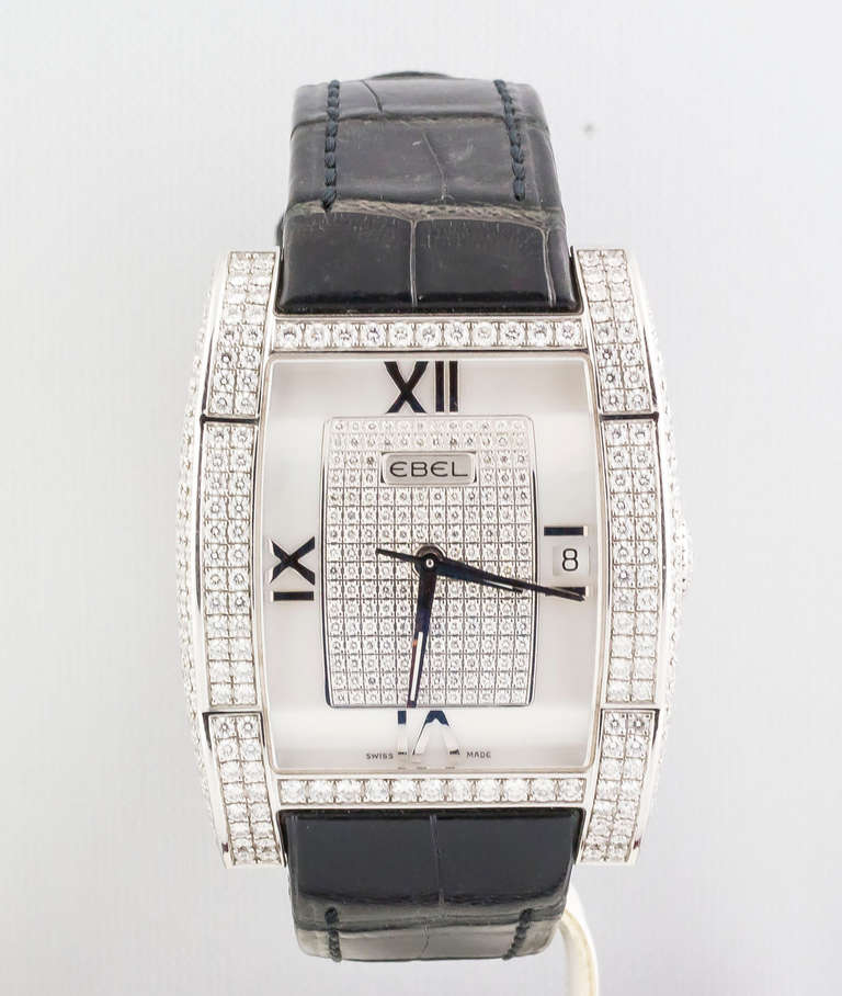 Ebel 18k white gold and diamond Tarawa wristwatch. It features a skeleton back, with date at 3 o'clock and Roman numerals. Automatic movement. High-grade factory-set round brilliant cut diamonds throughout the dial and bezel. Comes with original