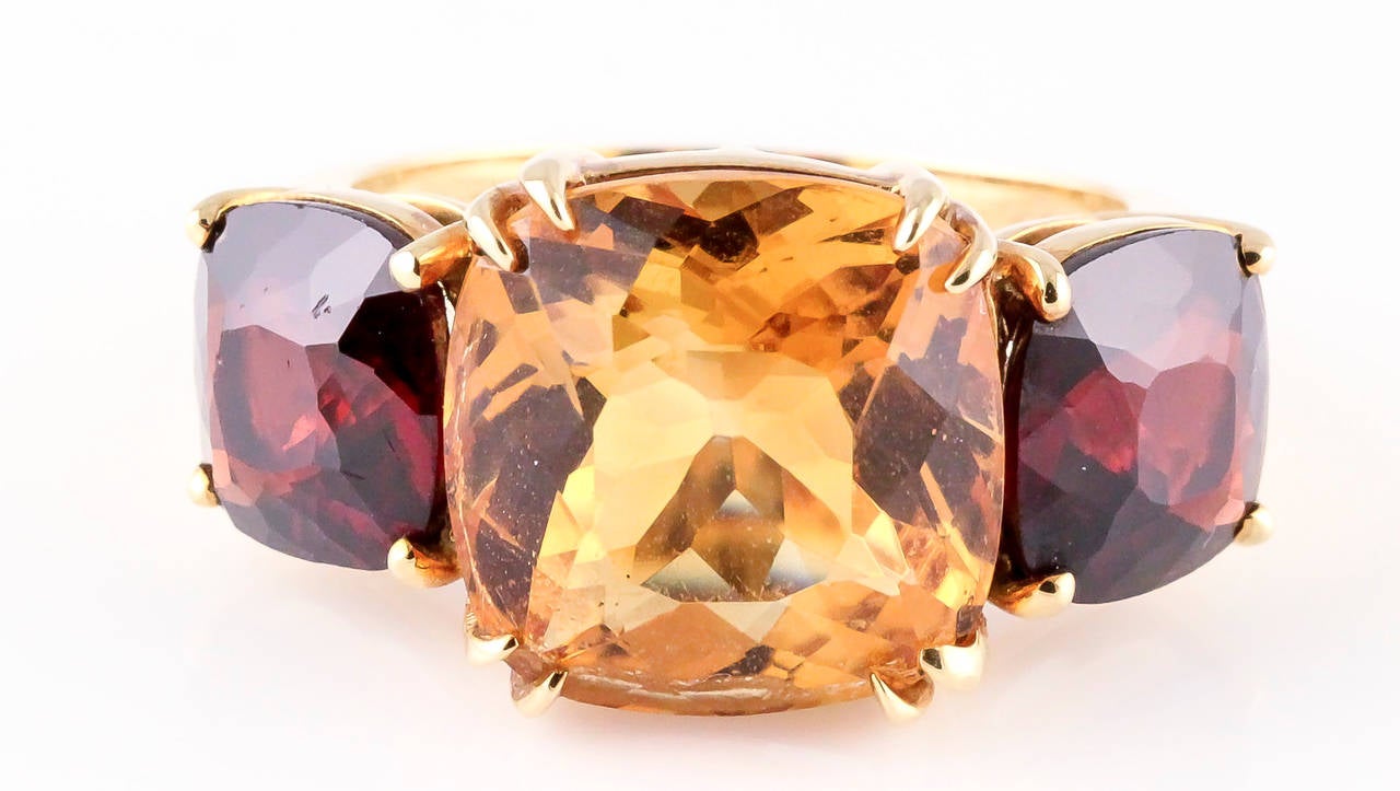 Unusual citrine, garnet and 18K yellow gold 3 stone ring by Seaman Schepps. Size 6.5. With signed box.

Hallmarks: Seaman Schepps, 750, copyright, maker's mark, reference numbers.