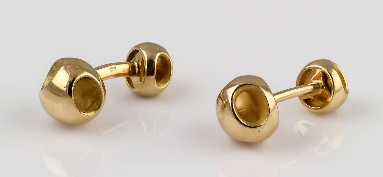 Interesting and unusual 18K yellow gold dumbbell cufflinks by Tiffany & Co., of French origin. They feature three holes on both ends, with polish exteriors and matte finish interiors.

Hallmarks: Tiffany & Co., 18K, France, makers mark, French 18K