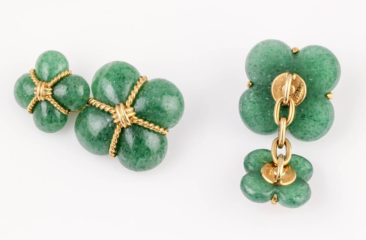 Unusual aventurine and 18K yellow gold cufflinks, circa 1960s, by Tiffany & Co. Aventurine is a type of quartz.  They feature a twisted rope gold design.

Hallmarks: Tiffany, reference numbers, 18kt, France.