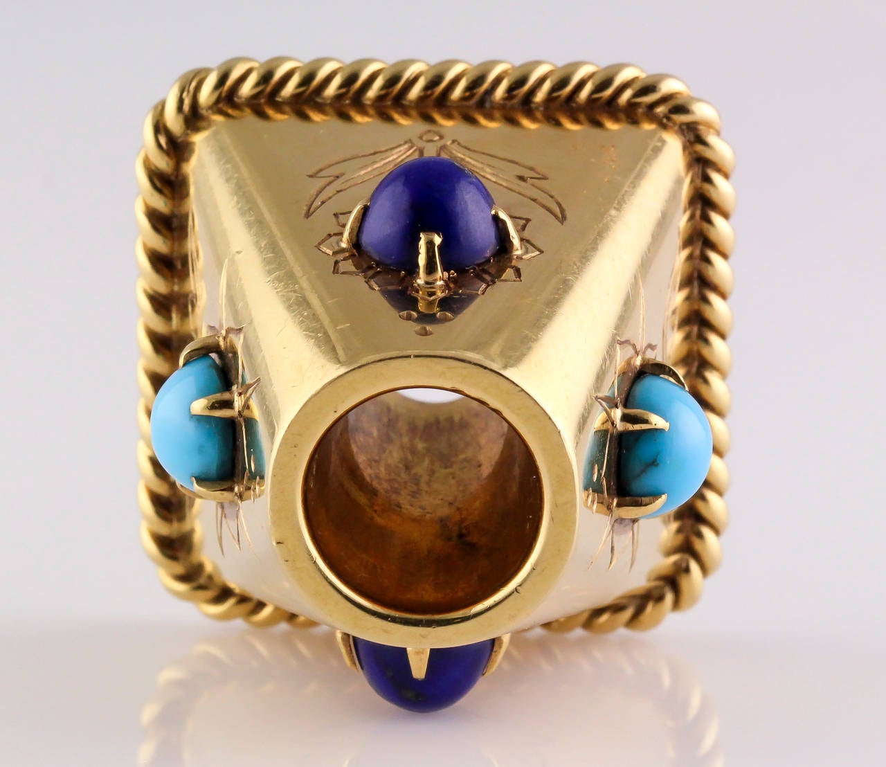 Rare and unusual turquoise, lapis and 18K yellow gold pen holder by Cartier London, circa 1940s. It features blue cabochon lapis stones on opposing ends, and light blue turquoise at other ends. Base has an eye catching twisted rope gold accent, and