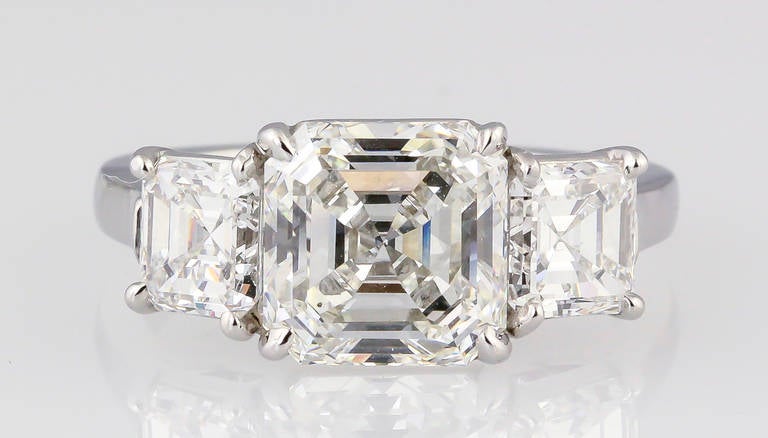 Timeless diamond and platinum three-stone engagement ring by Tiffany & Co. Features three square step cut diamonds. Central stone measures 3.02cts, while side stones are 1.65cts combined. Comes with GIA diamond certificate for central