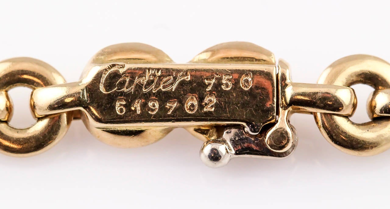 Chic and very rare 18K yellow gold, coral and blue lapis animal charm necklace by Cartier. It features a giraffe charm, gazelle charm, elephant charm, horse charm and a gorilla charm, all set with double sided cabochon lapis or coral stones. Only