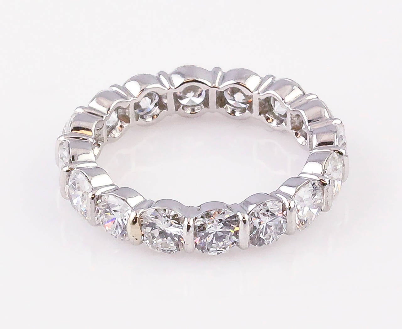 Chic diamond and platinum band by Tiffany & Co. It features a shared setting, with very high grade round brilliant cut diamonds, approx. 3.5cts total weight. Size 5.5. Approx. 4mm wide.

Hallmarks: T & Co., PT950.