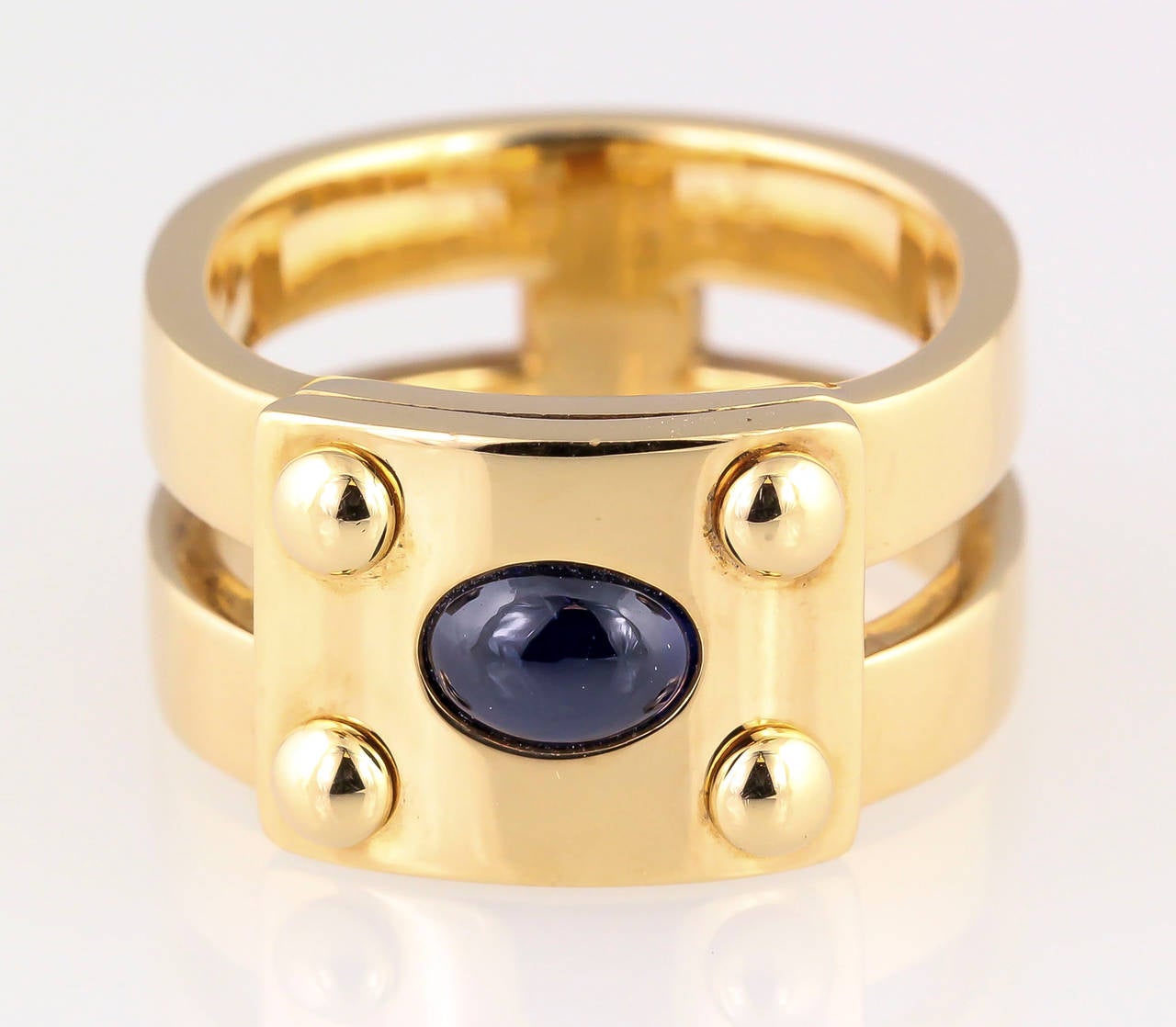 Elegant 18k yellow gold and cabochon sapphire ring by Hermes. Size 52.
Hallmarks: Hermes, 750, reference numbers, maker's mark, French 18K gold assay mark.