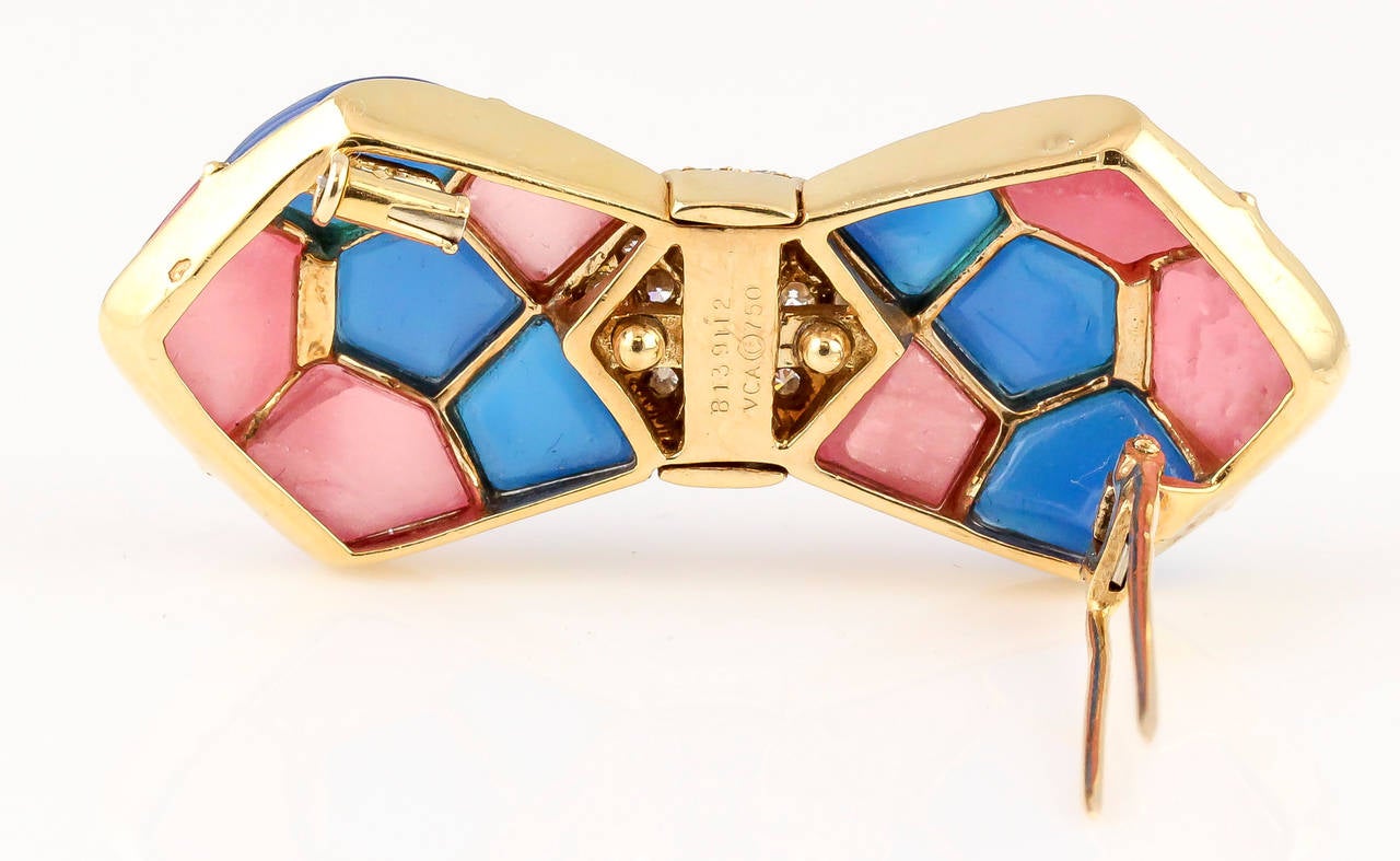 Rare and unusual 18K gold, diamond, chalcedony and rhodochrosite bow brooch by Van Cleef & Arpels. It features very high grade round brilliant cut diamonds at the center of the bow. 

Hallmarks: VCA, copyright, 750, reference numbers.