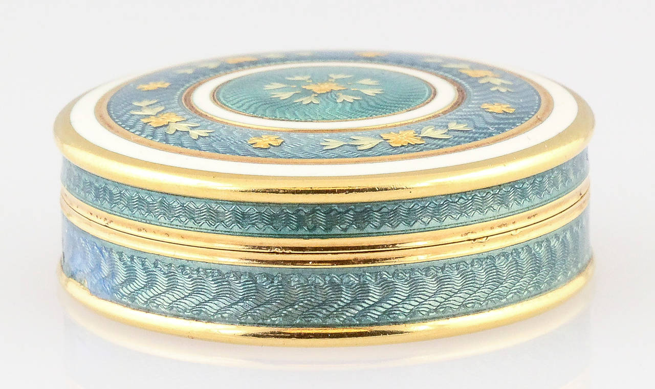 Rare and unusual white and teal enamel, on 18K yellow gold pill box of French origin, possibly circa 1930-40s. It features guilloche enamel. Some repair on enamel apparent, please see pictures.
Hallmarks: French 18K gold assay mark, maker's mark.