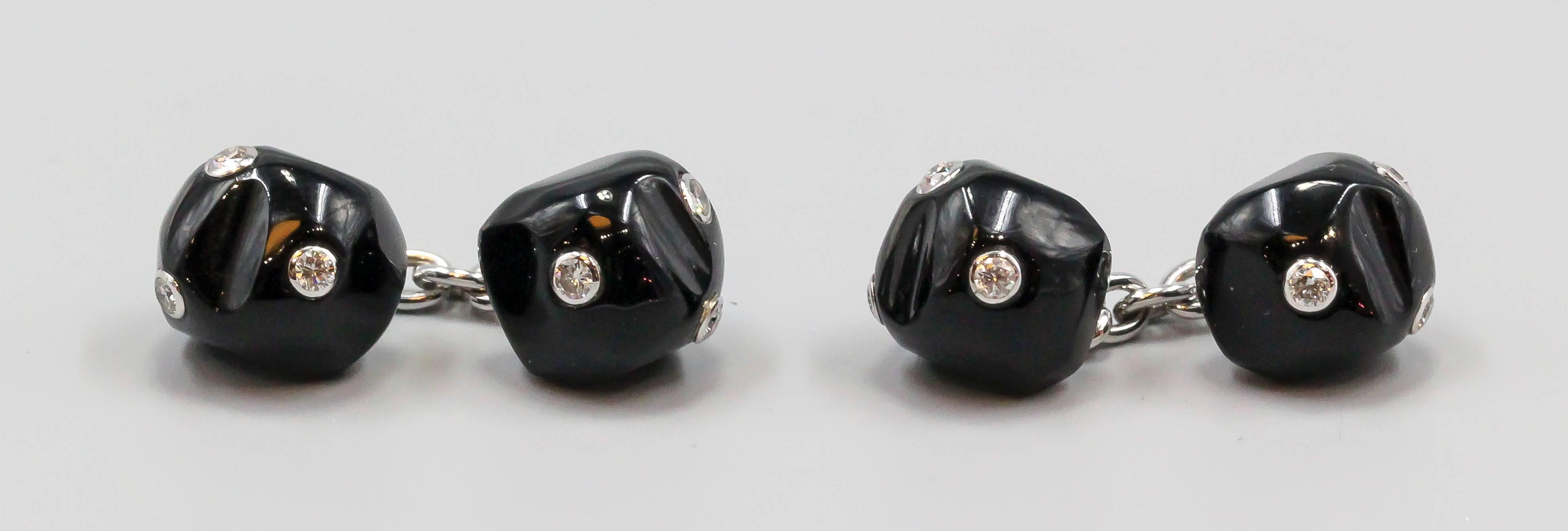 Handsome diamond, onyx and 18K white gold cufflinks by Trianon. They feature an asymmetrical shape, with high grade round brilliant cut diamonds set in 18K white gold bezels.

Hallmarks: Trianon maker's mark, reference numbers. 